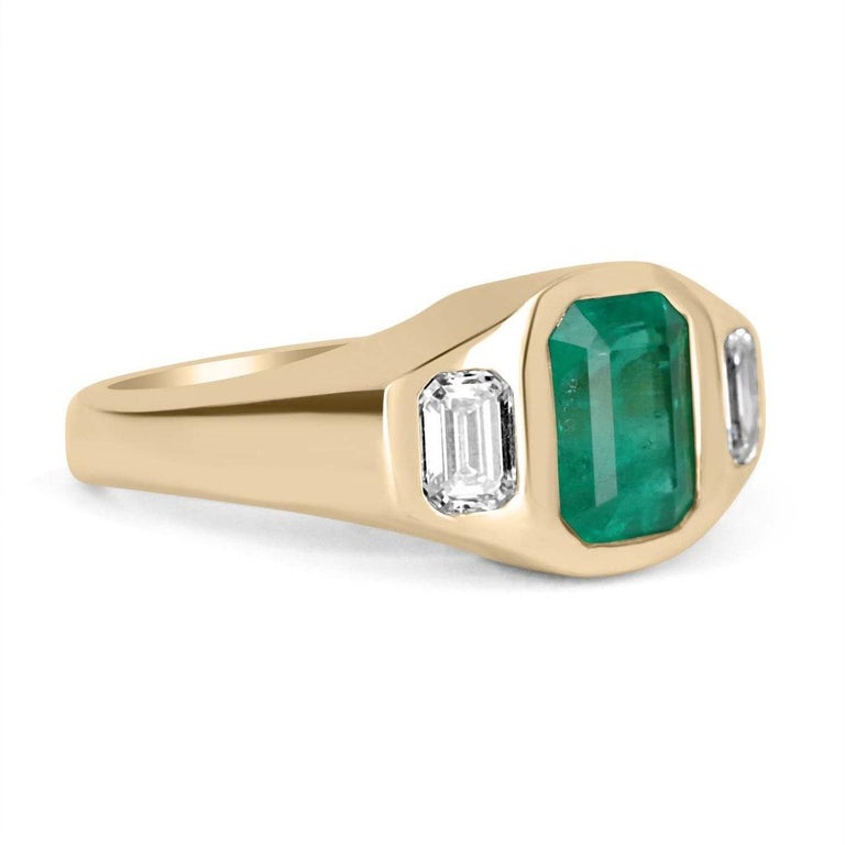 Featured here is a breath-taking, emerald and diamond three-stone ring. The center stone is a stunning 2.01-carat, Colombian emerald-emerald cut. This gemstone displays vivid green color and excellent luster. Accented on the sides are two