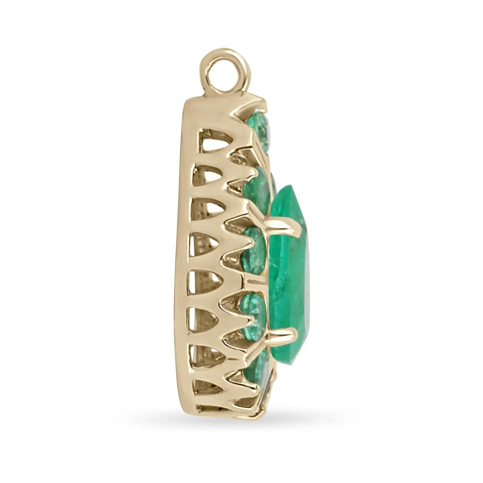 A ravishing, statement multi-stone Colombian emerald pendant. This lovely piece showcases a stunning 2.18-carat, natural pear-cut Colombian emerald right in the center. Numerous, natural, earth-mined round emeralds accent the center. The emeralds
