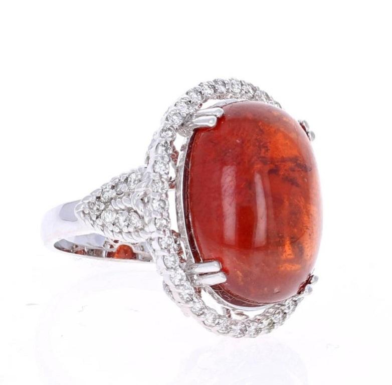 This beautiful ring has a 26.12 carat Cabochon Spessartine set in the center of the ring. A Spessartine is a natural stone that is actually a part of the Garnet family of stones. The ring is surrounded by 52 Round Brilliant Cut Diamonds that weigh