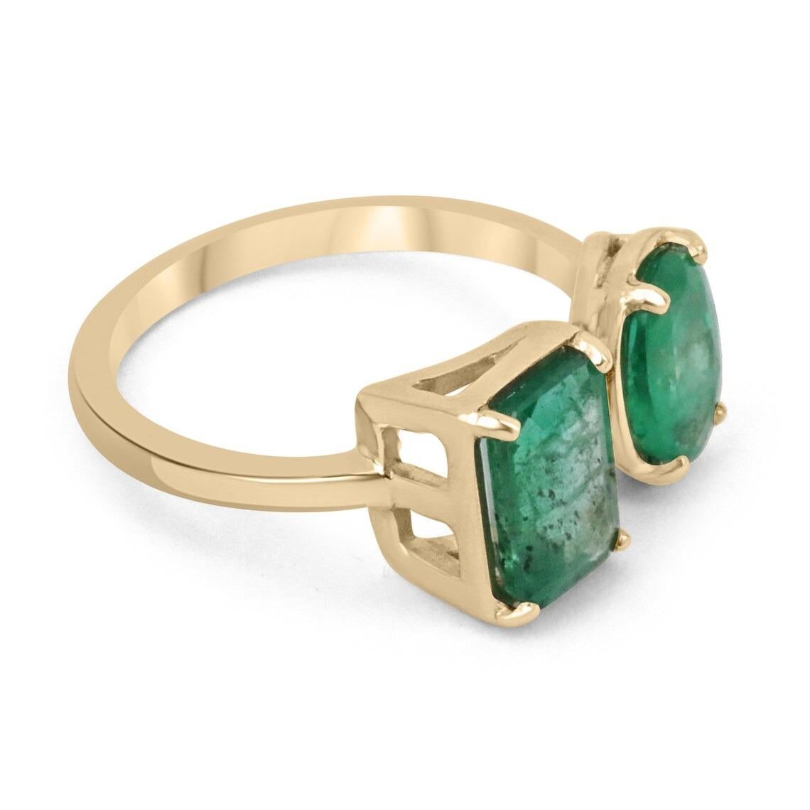 A stunning emerald cuff ring. This special and unique piece has two gorgeous emeralds. An emerald and oval cut emerald, showcasing remarkable characteristics, with an enchanting medium rich green color, and enthralling luster. Each stone is securely