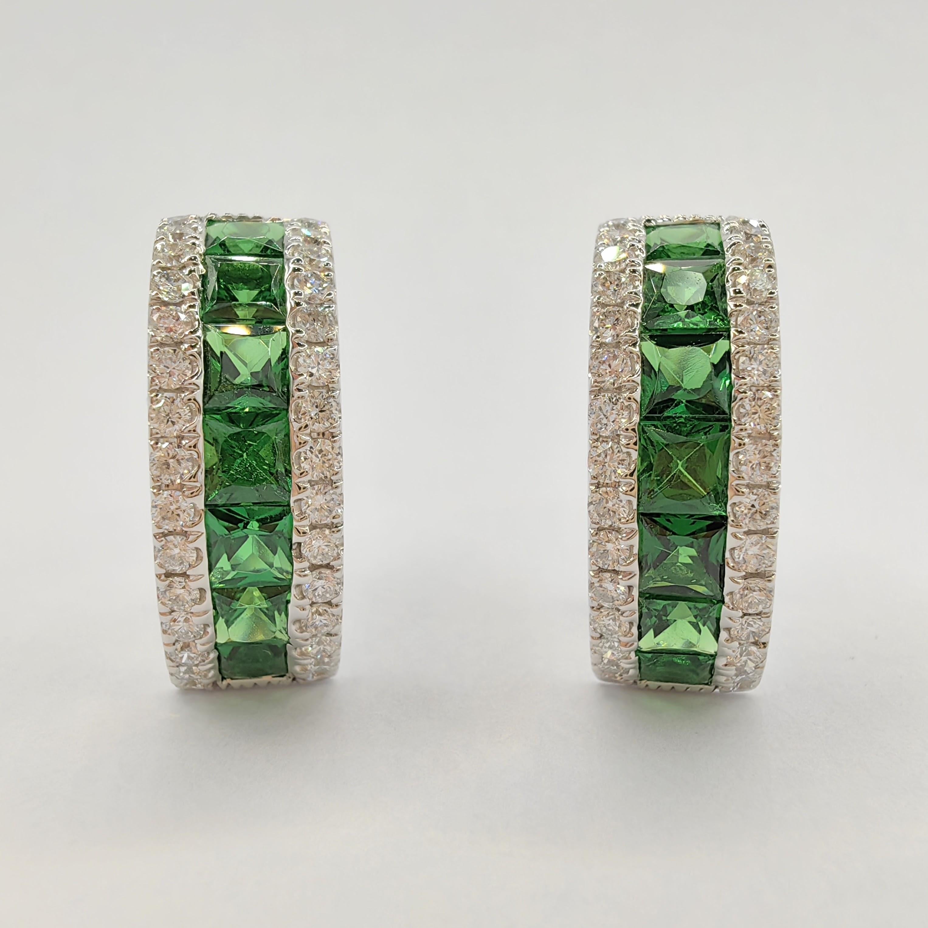Introducing our stunning 2.6ct Deep Green Tsavorite Diamond Huggie Hoop Earrings in 18K White Gold. These earrings are a perfect blend of elegance and vibrancy, designed to add a touch of sophistication to any ensemble.

The focal point of these