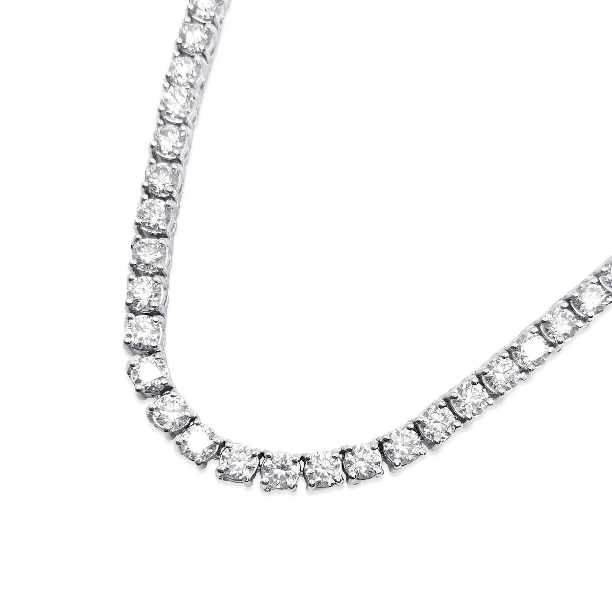 This necklace is made of 14-karat white gold. The diamonds on it weigh 26 carats and have very, very slight (VVS) clarity and are in an H color. These diamonds are all natural and mined from the earth. They are cut in a round brilliant style, making