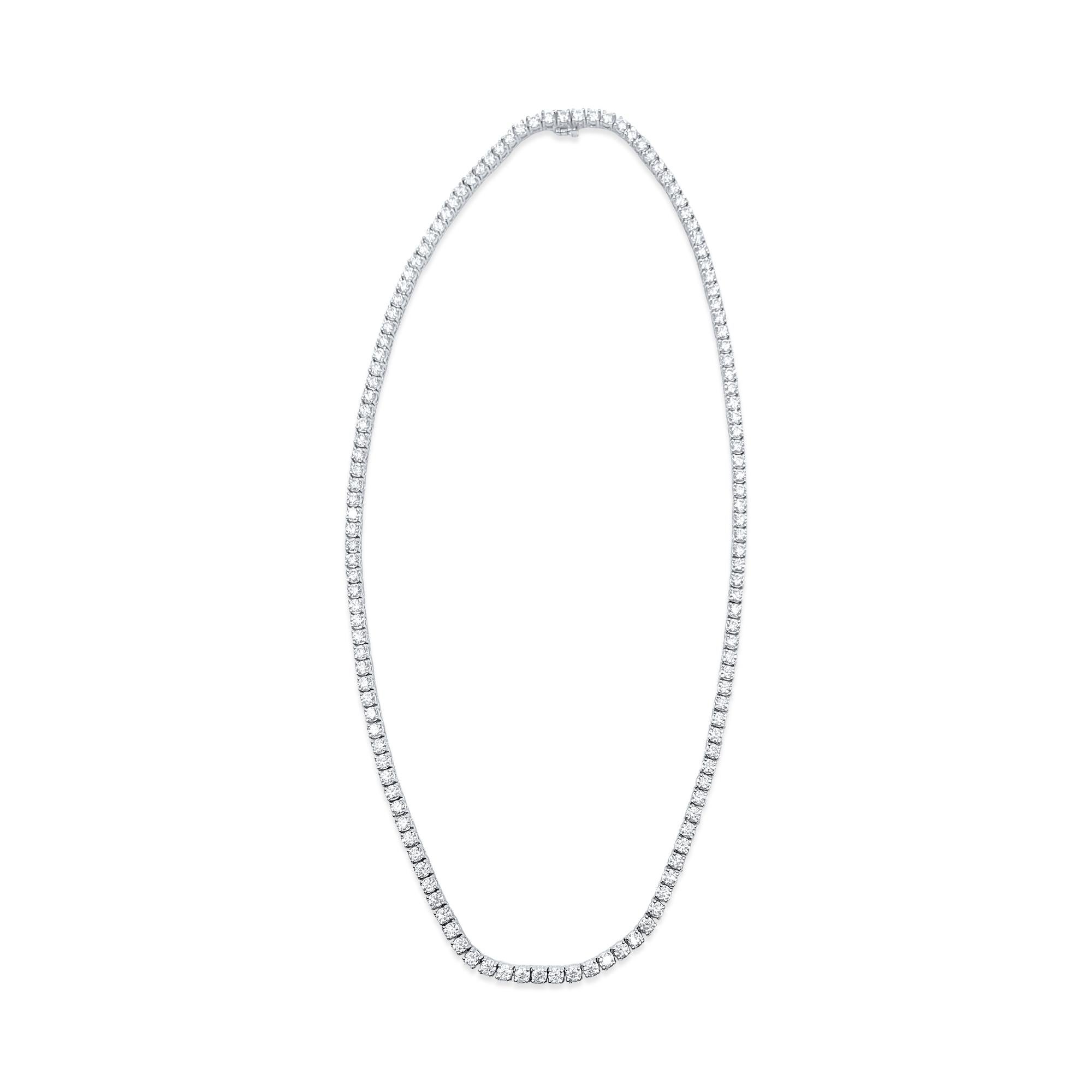 This necklace is made of 14-karat white gold. The diamonds on it weigh 26 carats and have very, very slight (VVS) clarity and are in an H color. These diamonds are all natural and mined from the earth. They are cut in a round brilliant style, making