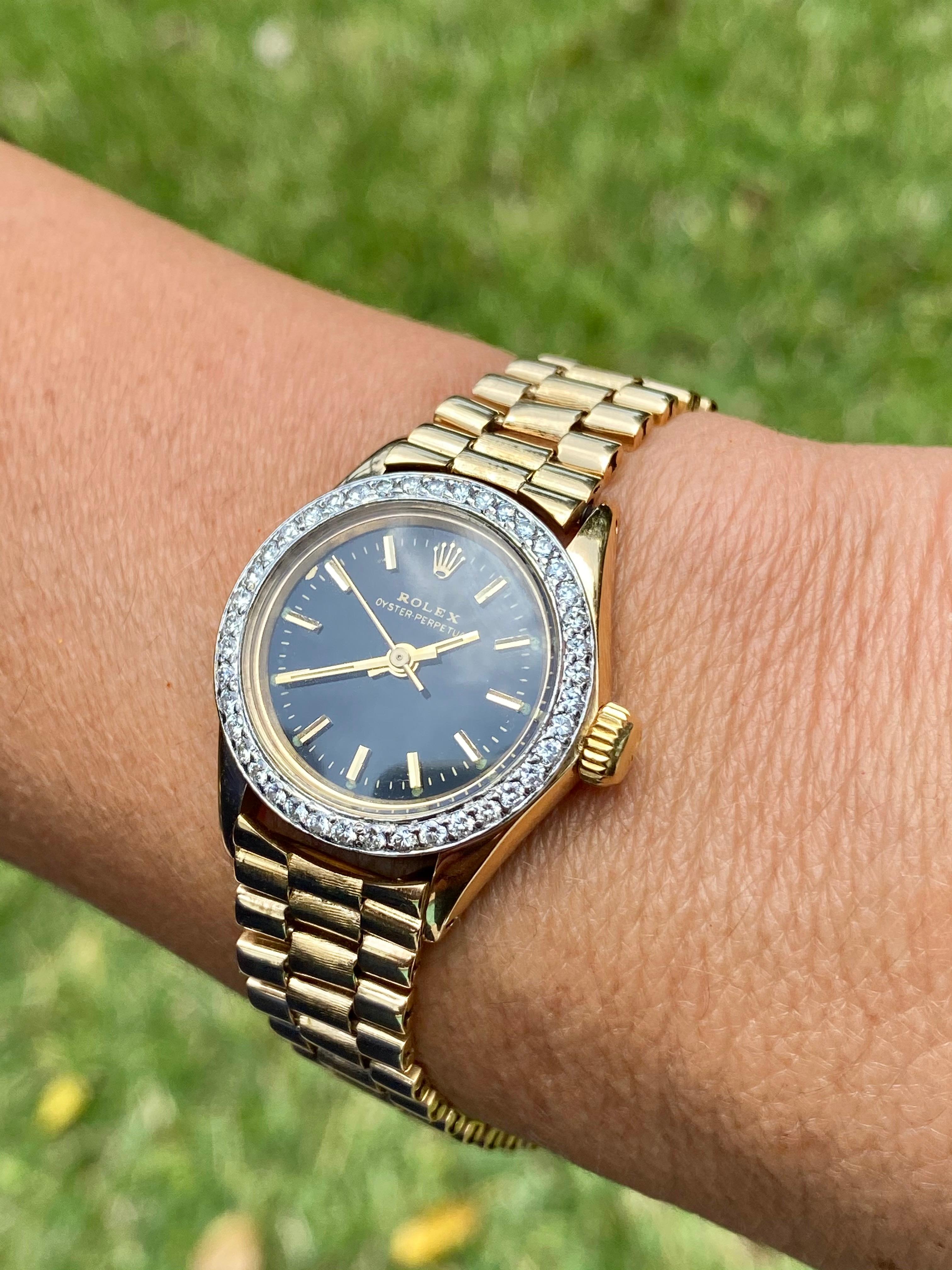 A Rolex Oyster Perpetual Watch Co. 18k gold wristwatch, rhodium-plated cal. 1400 movement with Jubilee bracelet, stick marker textured Black dial with stick hands. The bezel is adorned by 1.10 carats of natural round Diamonds. 

Details:
✔ Watch