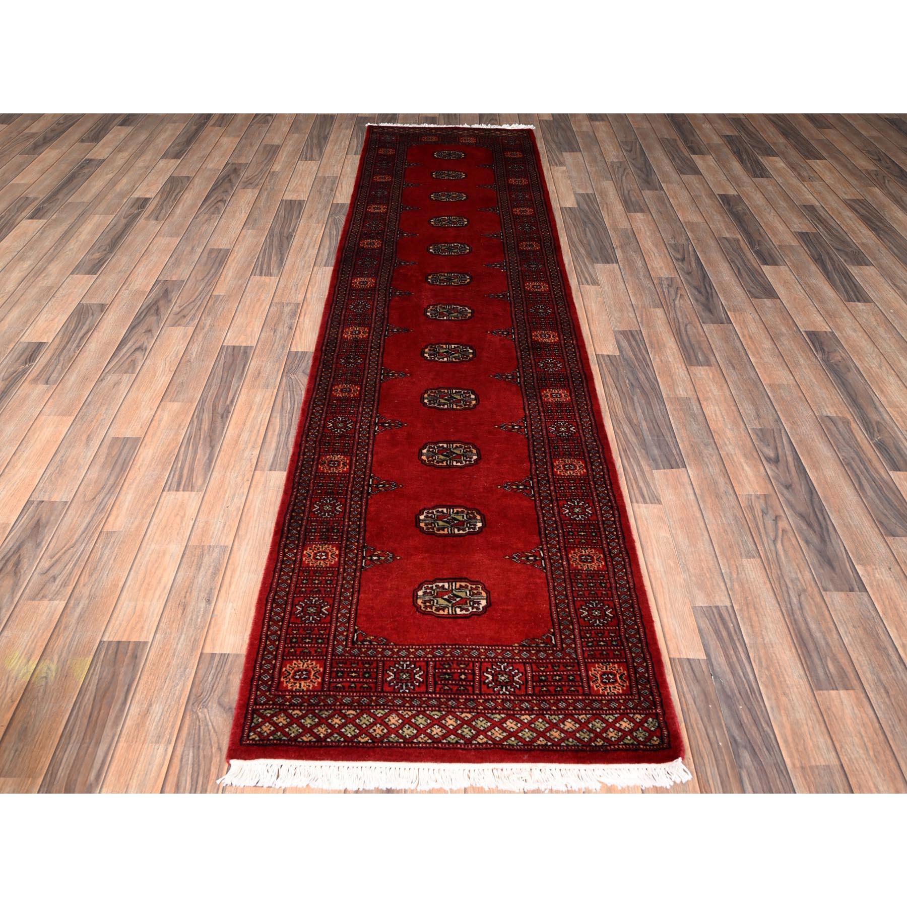 Cherry Red, Hand Knotted, Princess Bokara with Tribal Medallions, Natural Wool, Narrow Runner, Oriental Rug
Primary materials: Wool
Latex: No Pile 
height: 0.25 Inches
Style: Traditional
Primary color: Red
Secondary colors: Green, Peach, Ivory,