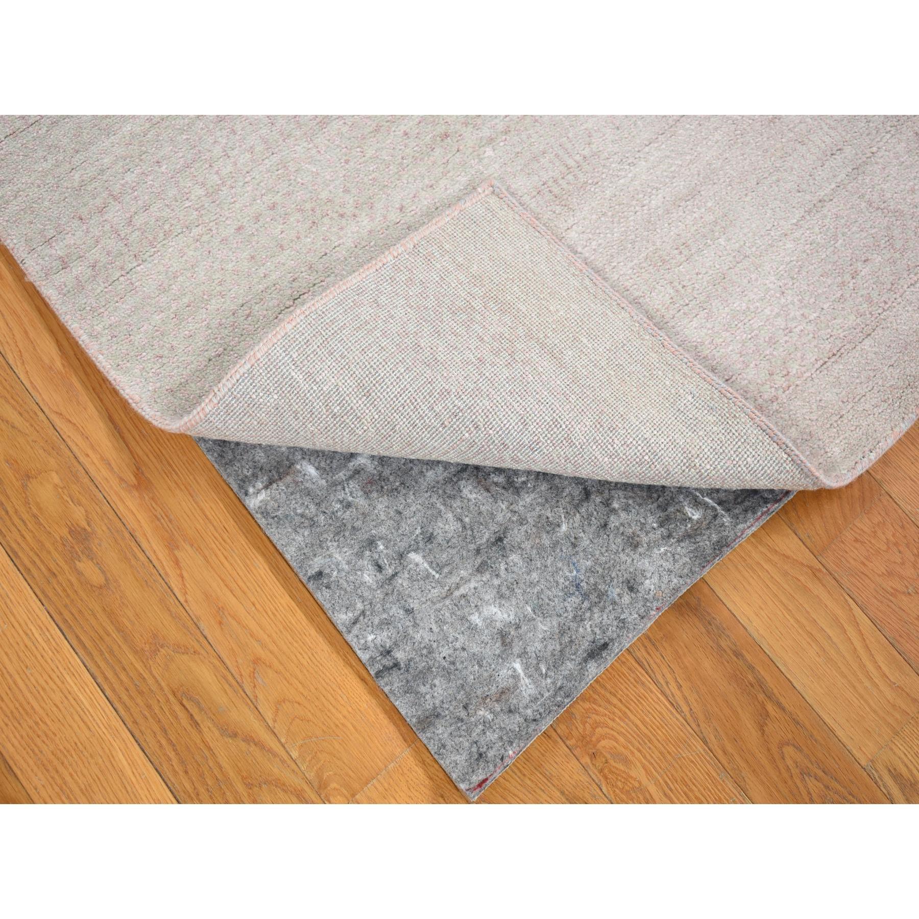 Il s'agit d'un véritable tapis d'Orient, unique en son genre, gris clair avec des touches de rose, au design moderne d'herbe, tissé à la main en laine et soie. Il a été noué pendant des mois et des mois selon la technique séculaire de l'artisanat du