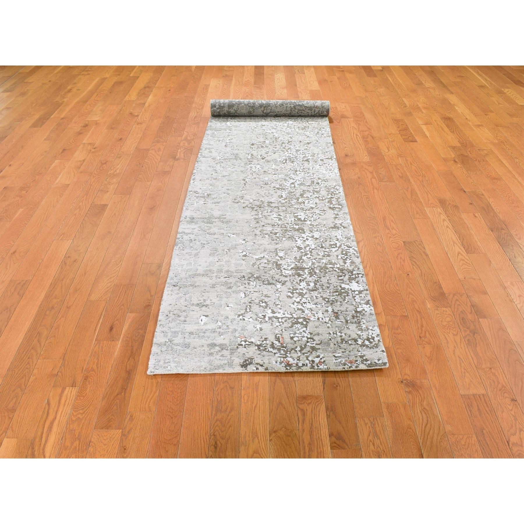 This is a truly genuine one-of-a-kind Gray Dense Weave Abstract Design Wool and Silk Hi-Low Pile Hand Knotted Runner Oriental Rug. It has been woven for months and months in the centuries-old Persian weaving craftsmanship techniques by expert