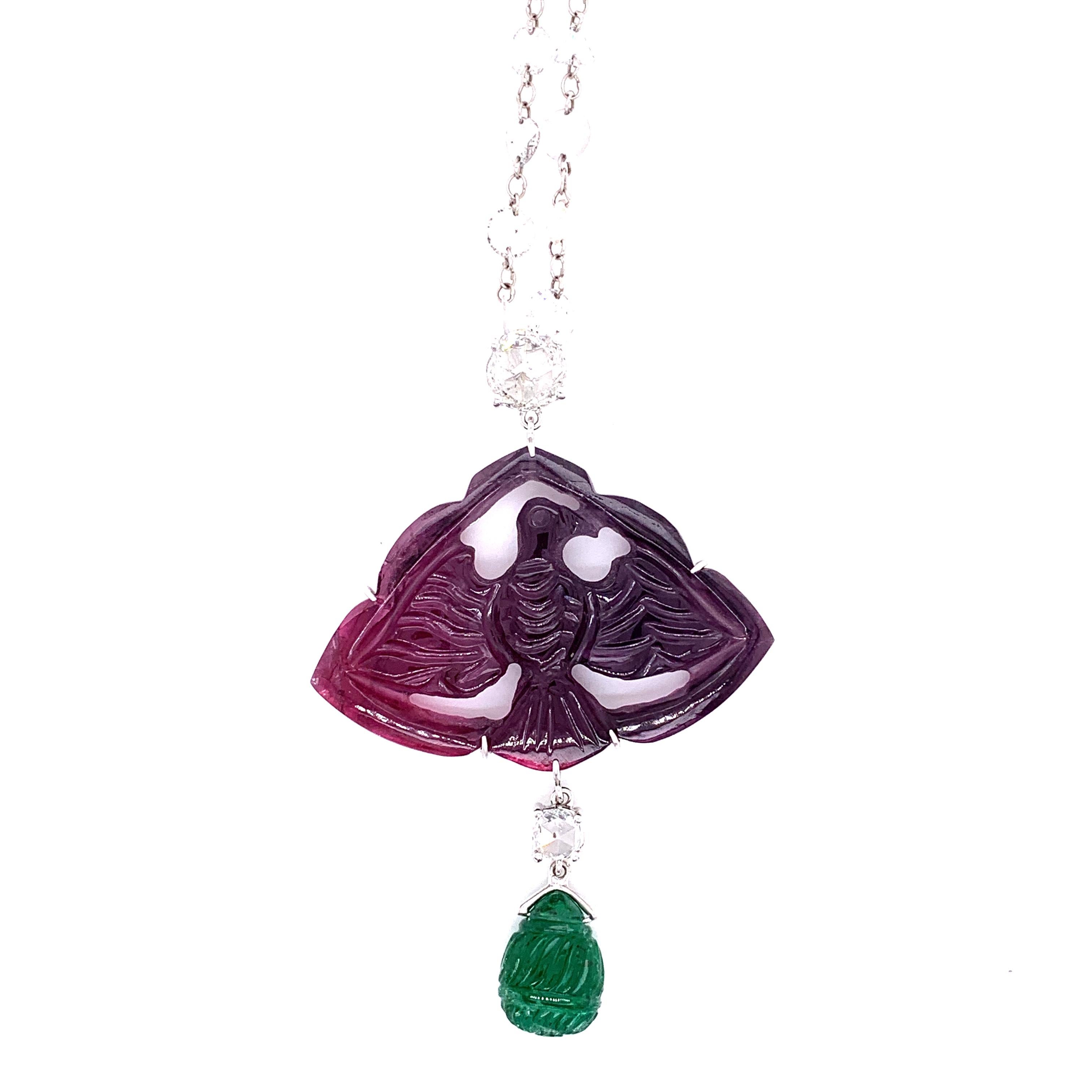 27 Carat Carved Mughal Tourmaline, Emerald, and White Diamond Gold Necklace :

A very beautiful and rare jewel, it features a gorgeous Mughal-era carved tourmaline weighing 27.29 carat as well as a Mughal-era carved emerald drop weighing 4.89 carat,