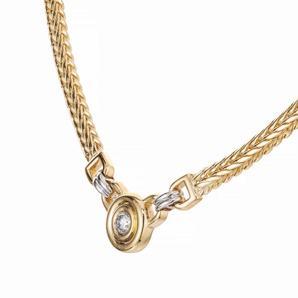 Diamond pendant necklace. .27 carat bezel set diamond. 14k yellow gold 17 inch wheat chain with 14k white gold ring connectors.  

1 round brilliant cut diamond, I-J VS approx. .27cts
14k yellow gold 
14k white gold 
Stamped: 14k
24.6 grams
Top to