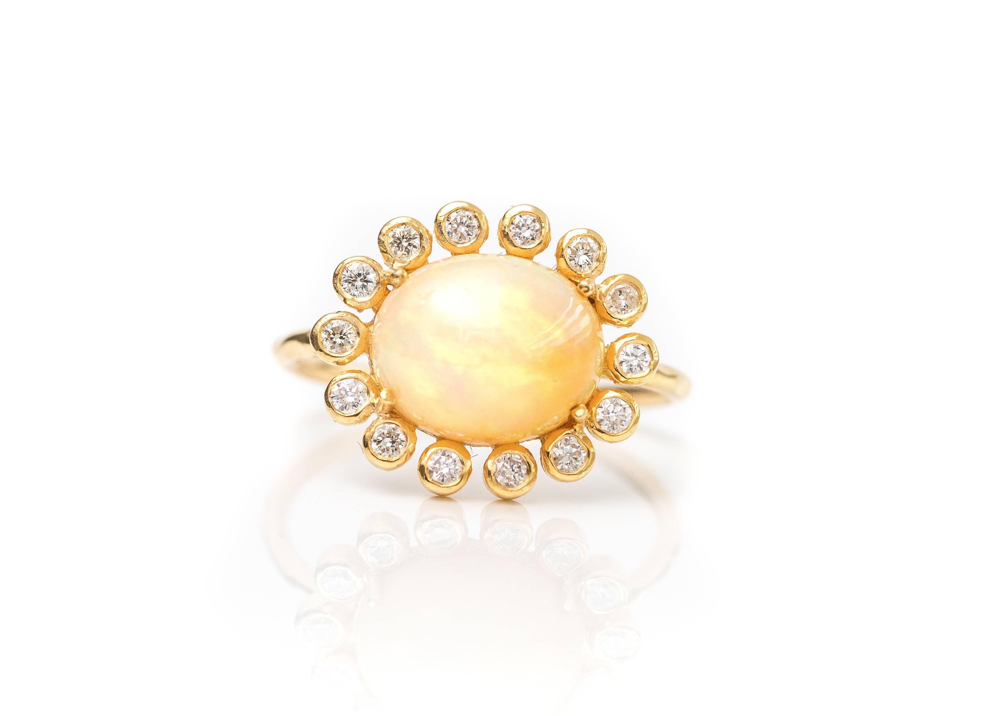 2.7 carat Opal with Diamond Halo and 18 Karat Yellow Gold Ring

Features a 2.7 carat Ethiopian Opal center stone, a Diamond Halo and 18 Karat Yellow Gold. The stunning Oval Opal center stone is prong set in an East-West direction. This brilliant