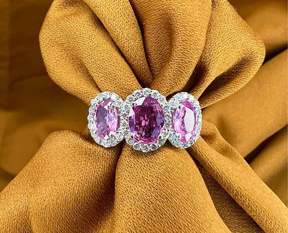 Sapphire Weight: 2.71 CTs, Measurements: 8x6/7x5 mm, Diamond Weight: 0.48 CTs, Metal: 18K White Gold, Gold Weight: 5.46 gm, Ring Size: 7, Shape: Oval, Color: Pink, Hardness: 9, Birthstone: September