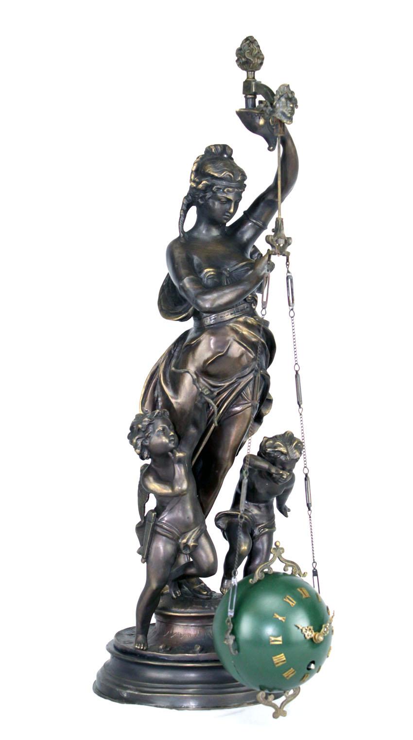 Rare Mystery Brass Lady Cherub Upside Down Chain Ball Swinging Clock

An excellent tall lady double cherub statue upside down ball swinging clock. It has a mechanical movement inside the ball and hanging down from the lady's hand. Yet, as the clock