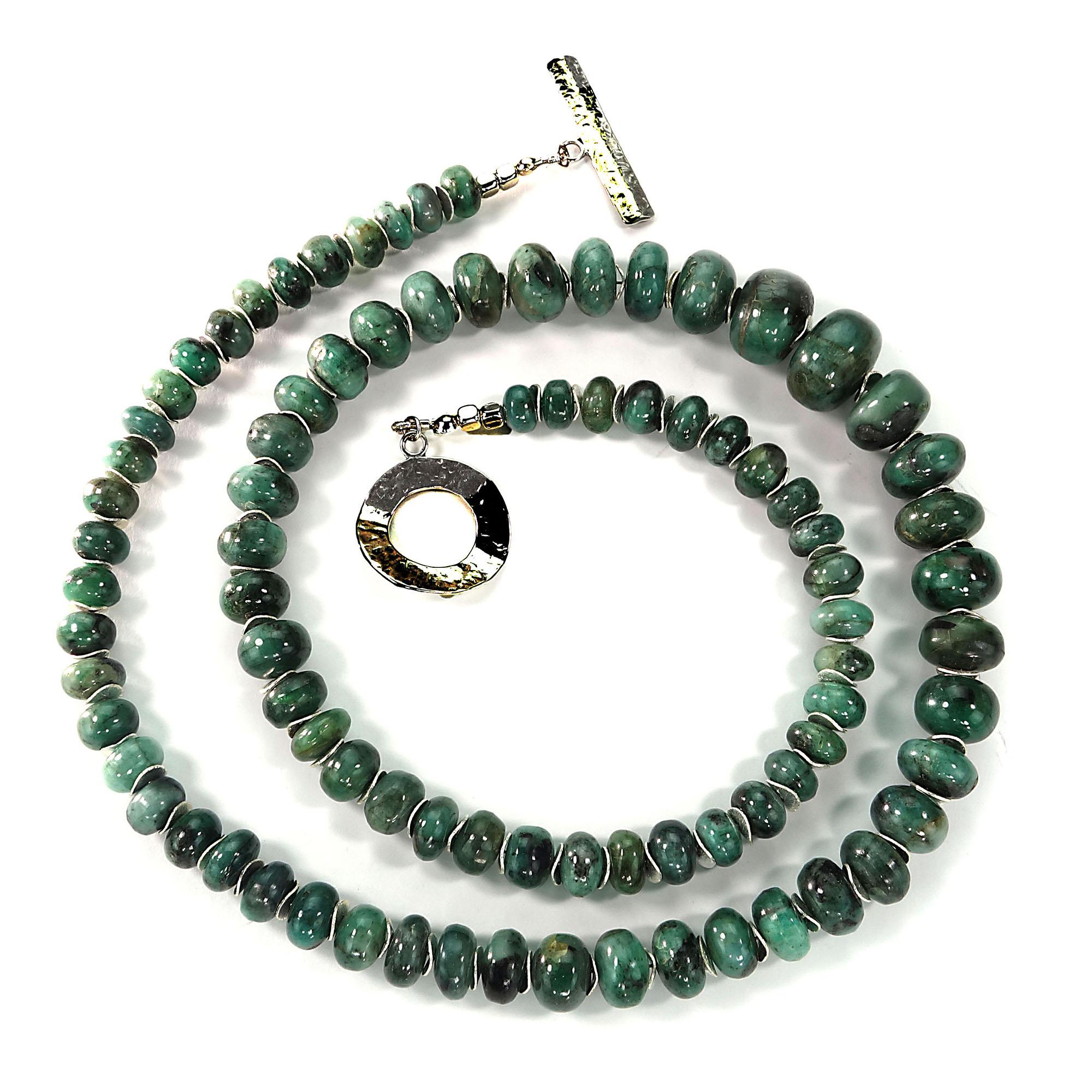 Graduated Emerald in matrix 8-17MM rondelles enhanced with silver tone flutters and a Sterling Silver toggle clasp.  This handmade necklace is a substantial 27 inch length.  Emerald is the May birthstone.