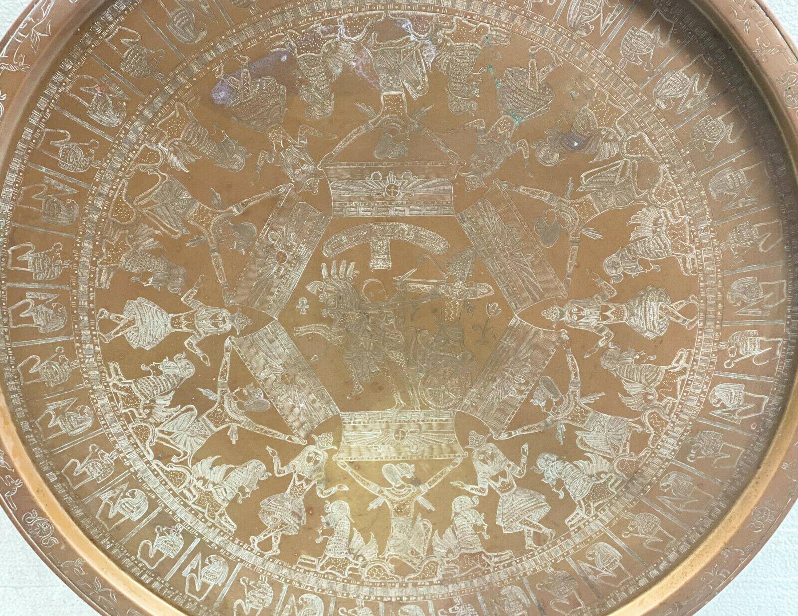 27 inches Middle Eastern Egyptian copper & enamel centerpiece tray platter, circa 1930.

White enamel to the engraved Egyptian figures throughout the tray.

Additional Information:
Dimension: 27 inches diameter.
Condition: Great related
