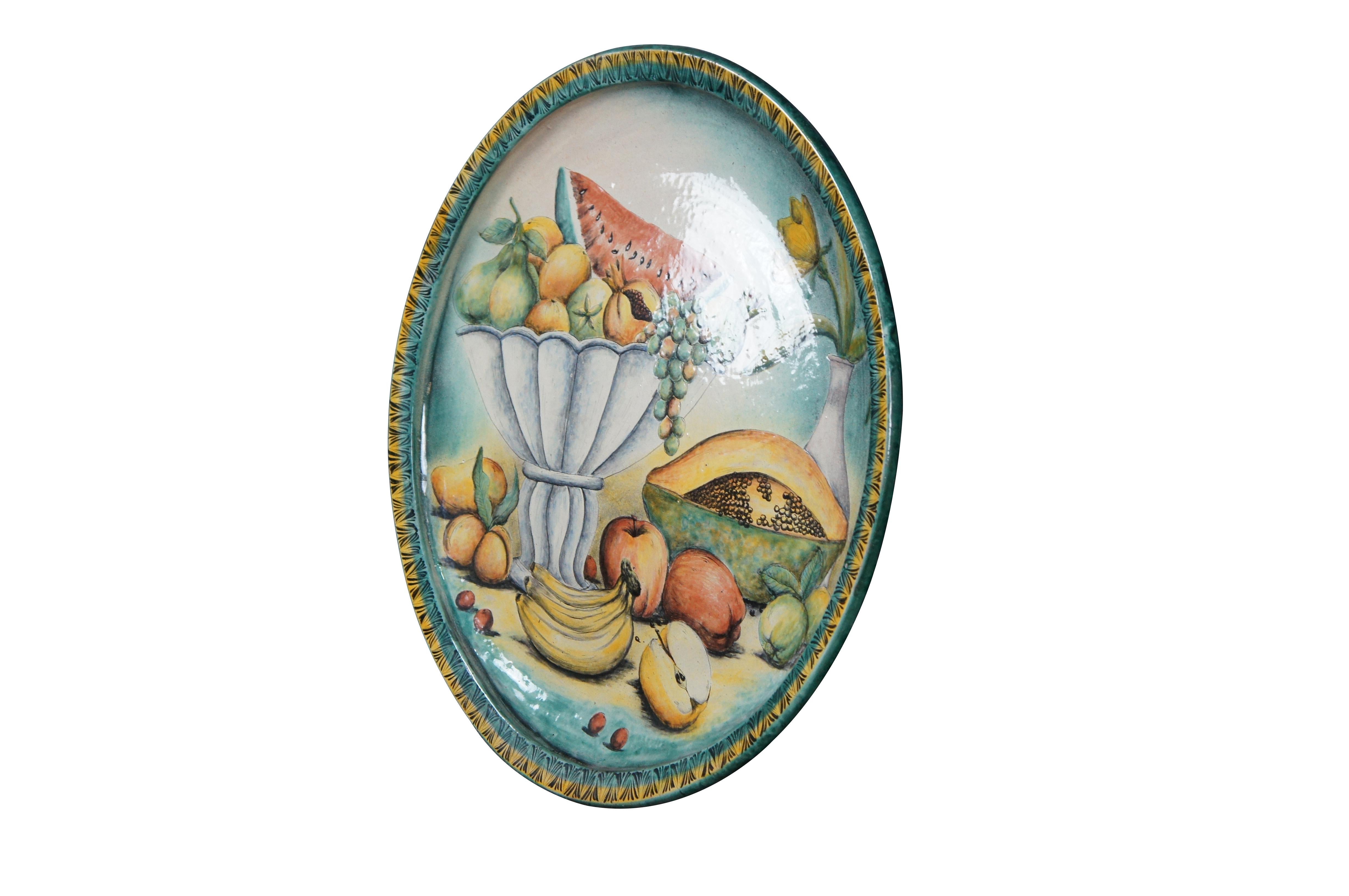 A beautiful 20th century Majolica Platter / Decorative Wall Plate. Made in Santa Rosa de Lima (Villagrán), Guanajuato. Features a hand painted still life of a compote with pears, grapefruit and a watermelon. A papaya, apples, bananas and more fruit