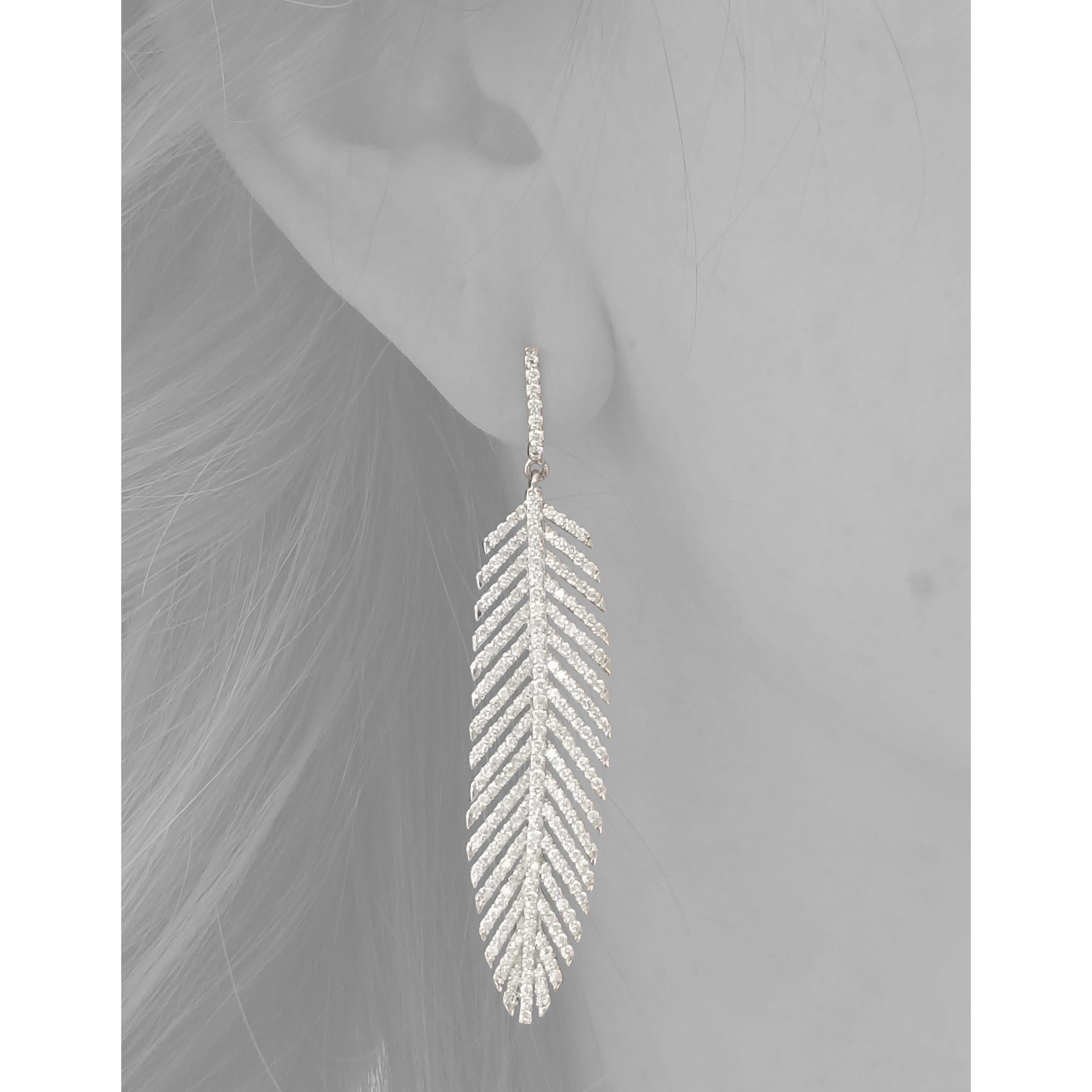 These exquisite platinum feather earrings are handset with gorgeous quality diamonds. The feathers move freely, adding playfulness to the graceful sophistication which they exude. The weight of the platinum is not overwhelming, as these were