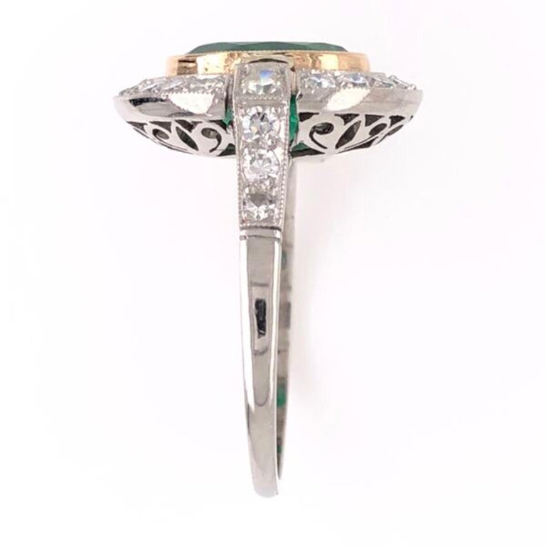 Elegant & finely detailed Solitaire Cocktail Ring, center set with an oval 2.70 Carat Emerald surrounded by Diamonds, weighing approx. 0.72 Carat total weight. Hand crafted in Platinum. The ring epitomizes vintage charm and would make a lovely
