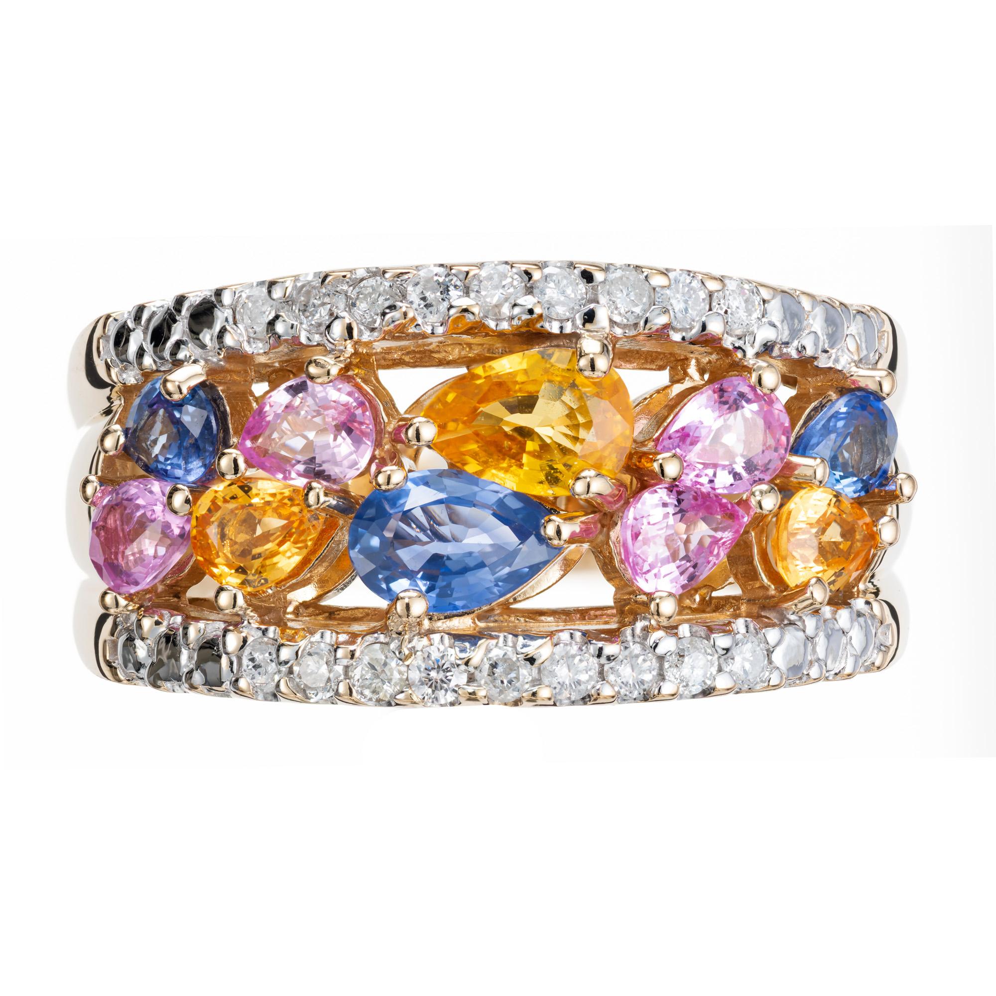 Dazzling multi color sapphire and diamond band ring. 10 mixed colored blue, yellow and pink pear shaped sapphires set in a 14k yellow gold open work setting. Framed with two rows of 18 full cut round white diamonds. 

18 full cut diamonds approx.