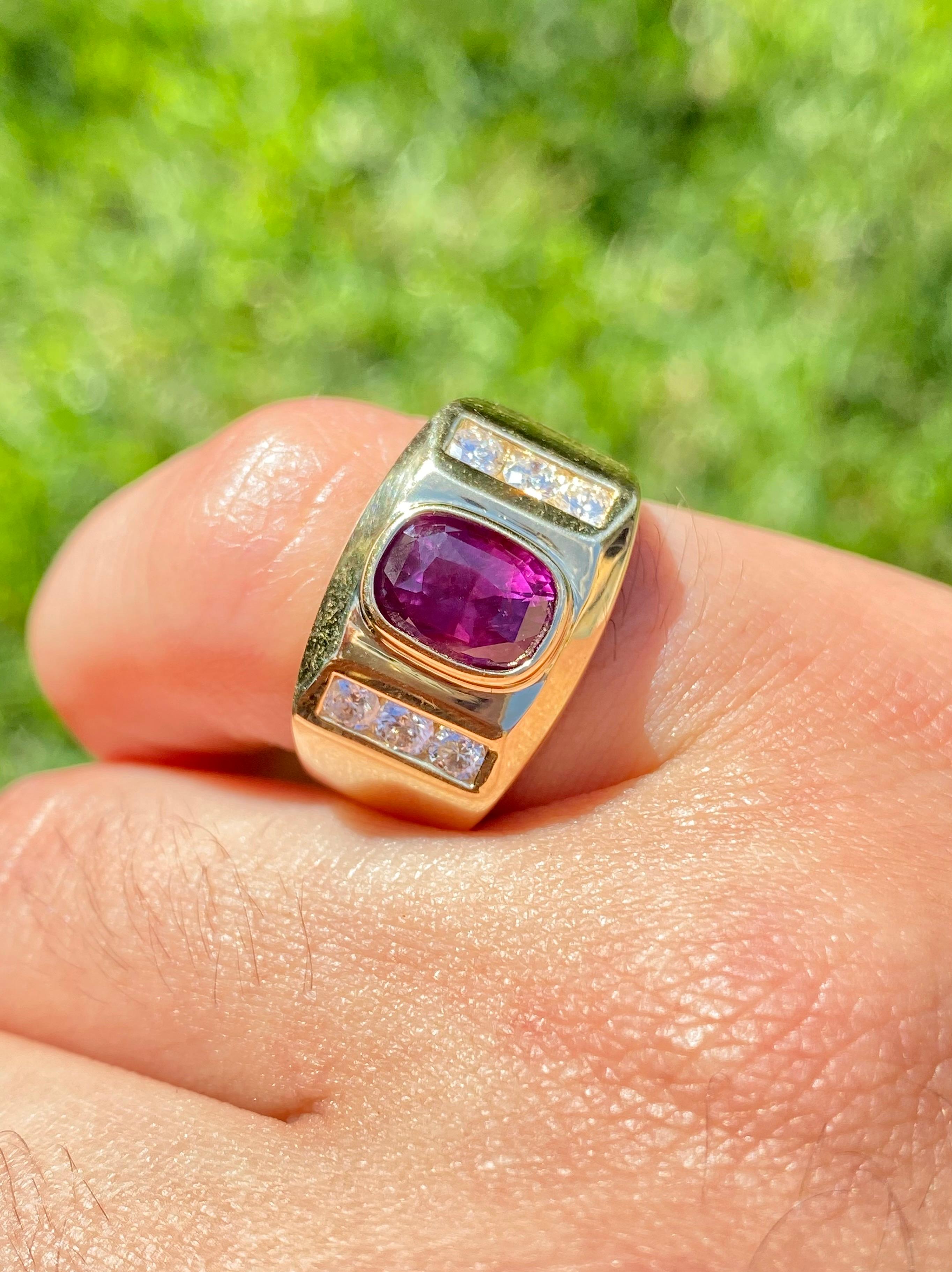 Centering a lovely Oval-Cut Purplish Red 2.70 Carat Ruby, framed by 6 Round-Brilliant Cut Diamonds totaling 0.45 Carats, and set in 14K Yellow Gold, this iconic Men's Ring design has stood the test of time.

Ring Details:
✔ Stone: Ruby
✔ Stone
