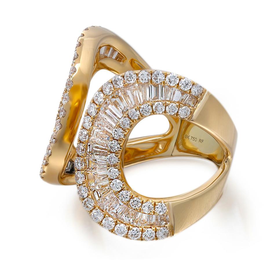 The Round and Baguette Cut Diamond Fashion Ring is a mesmerizing piece that showcases a harmonious blend of classic and modern design. Featuring a round-cut diamond as the focal point, this ring is surrounded by a halo of smaller round diamonds,