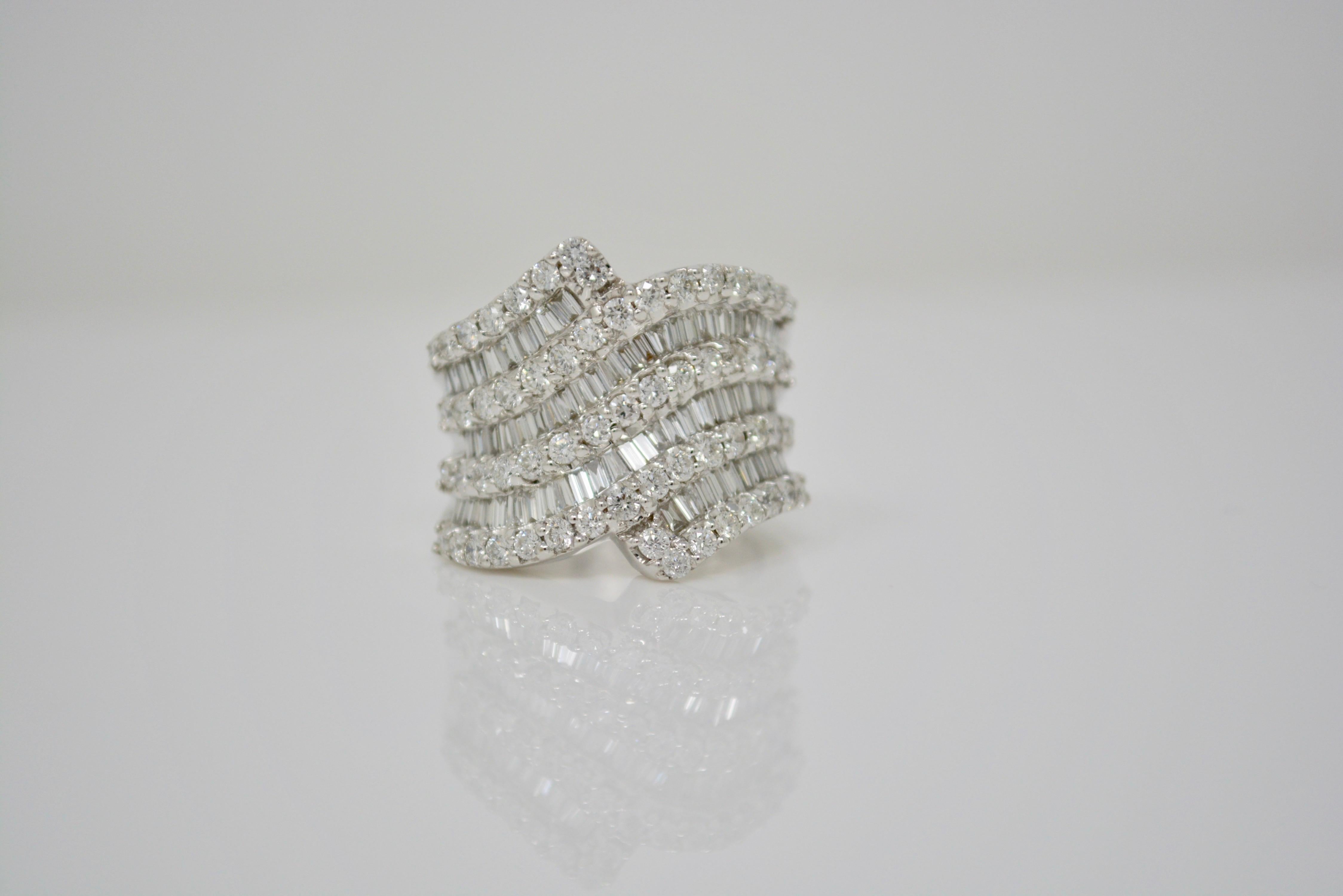 Looking for a unique diamond statement ring with big look ? Look no further ! This stunning 18 K white gold ring features a total diamond weight of 2.70 carat white round brilliant and baguette diamonds with G-H color and VS clarity . The ring size