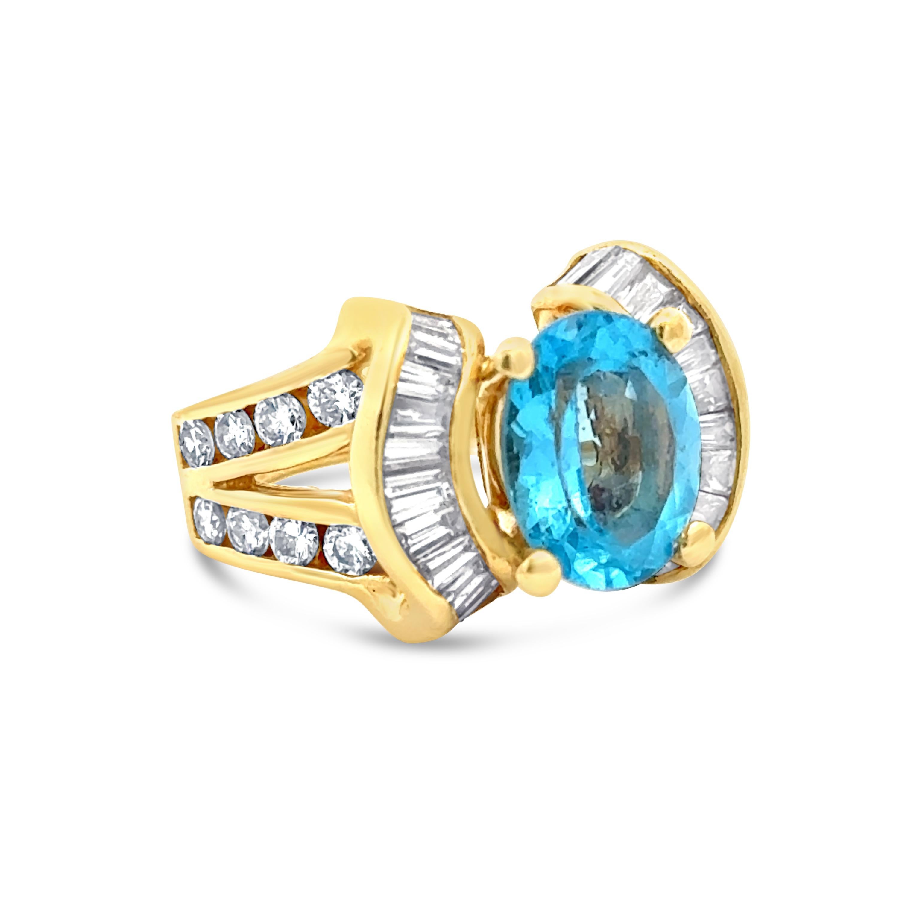 A wonderful vintage fashion ring, featuring a 2.70 carats oval cut aquamarine center stone. Flanked by channel-set baguette cut diamonds and accented by a split-shank with round brilliant cut diamonds, set in a half-way design. Accent diamonds weigh