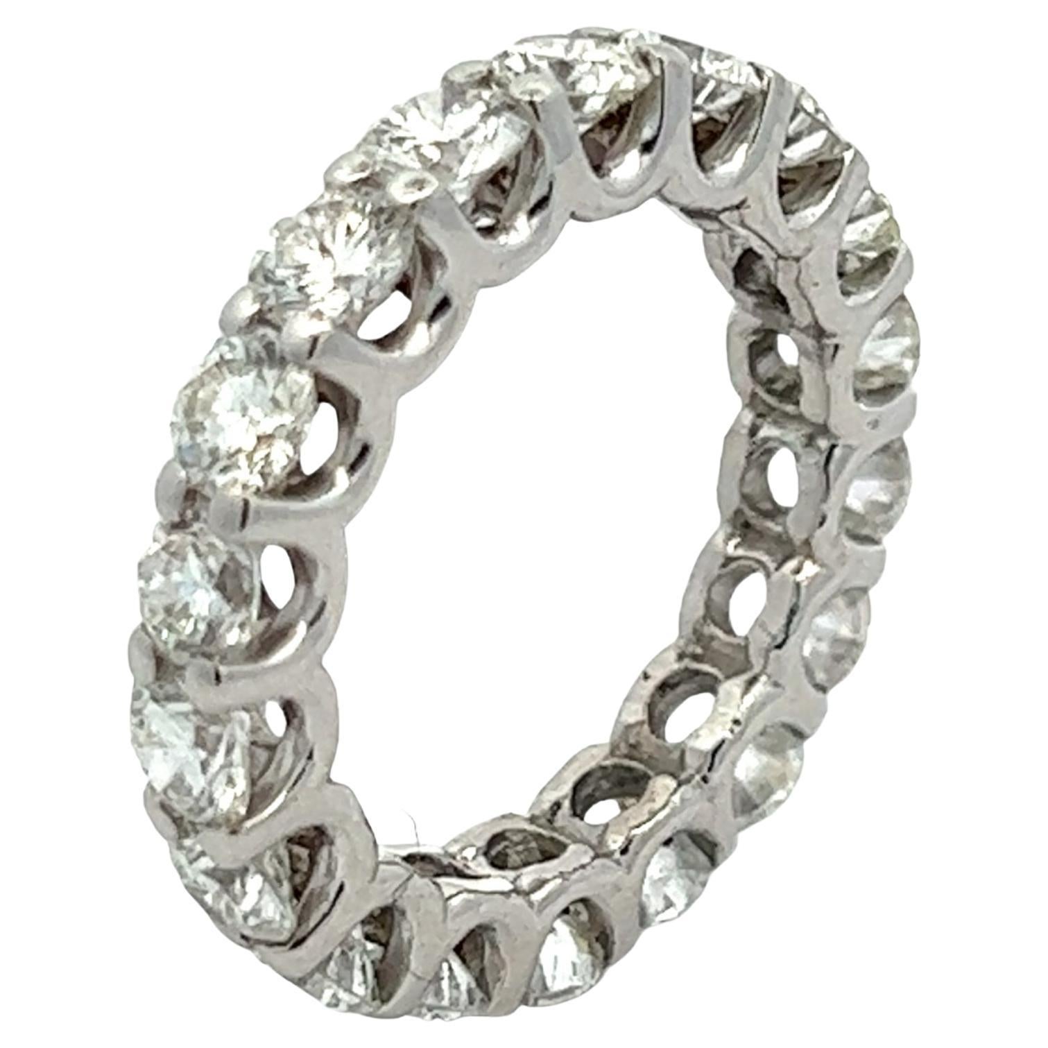 Beautiful diamond eternity wedding band handcrafted in 18 karat white gold. The band features 18 round brilliant cut diamonds weighing approximately 2.70 carat total weight and graded F-G color and VS2-SI1 clarity. The ring is size 3.75. 