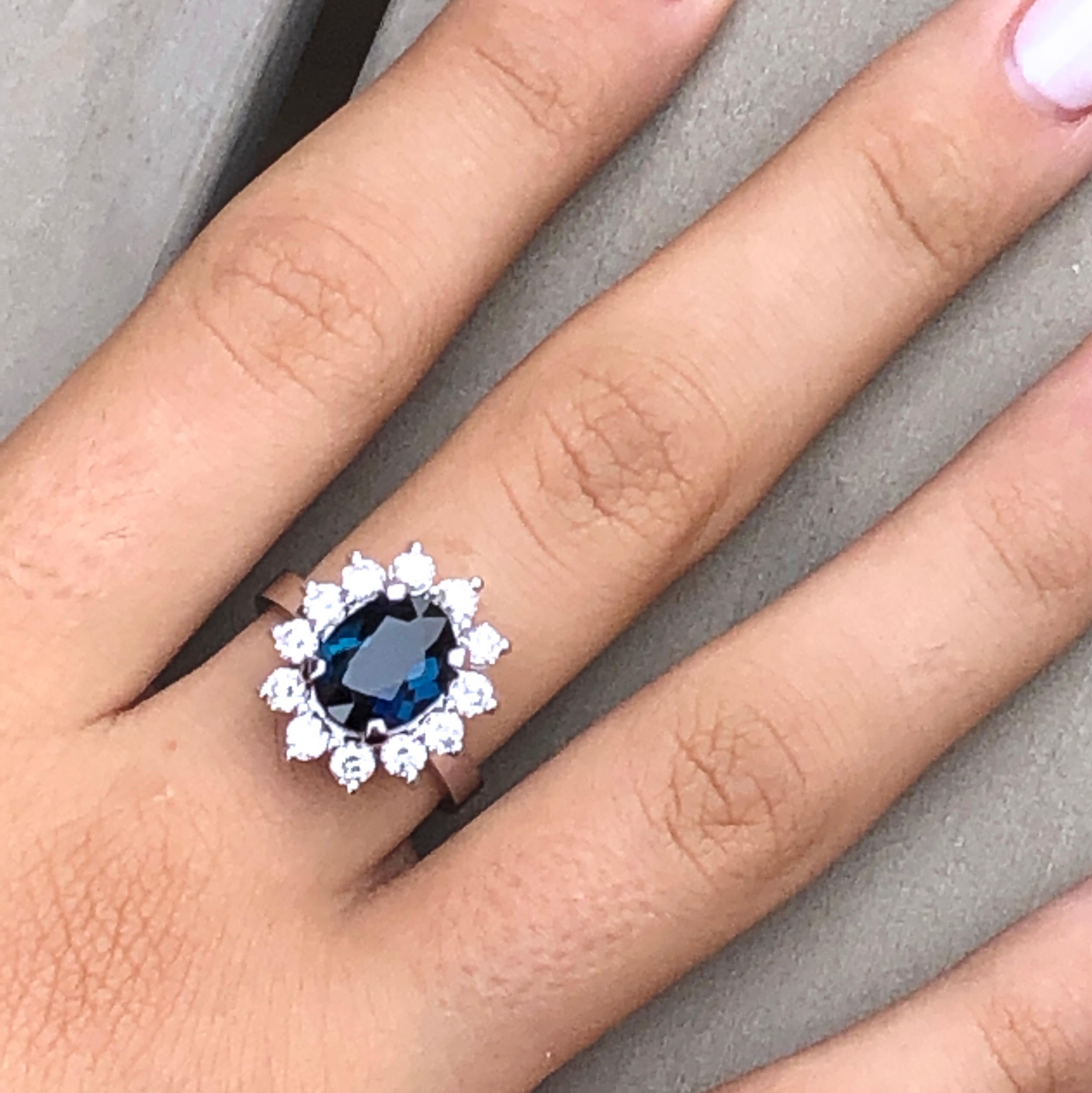 One-of-a-kind 2.70 Carat Oval Cut Indicolite, a Rare Indigo-Blue Tourmaline (0.317x0.399) in a smart and timeless White Diamond (1.02kt, D-E VVs1) 18 kt White Gold Ballerina Setting. The color of this beautiful stone is absolutely natural, not