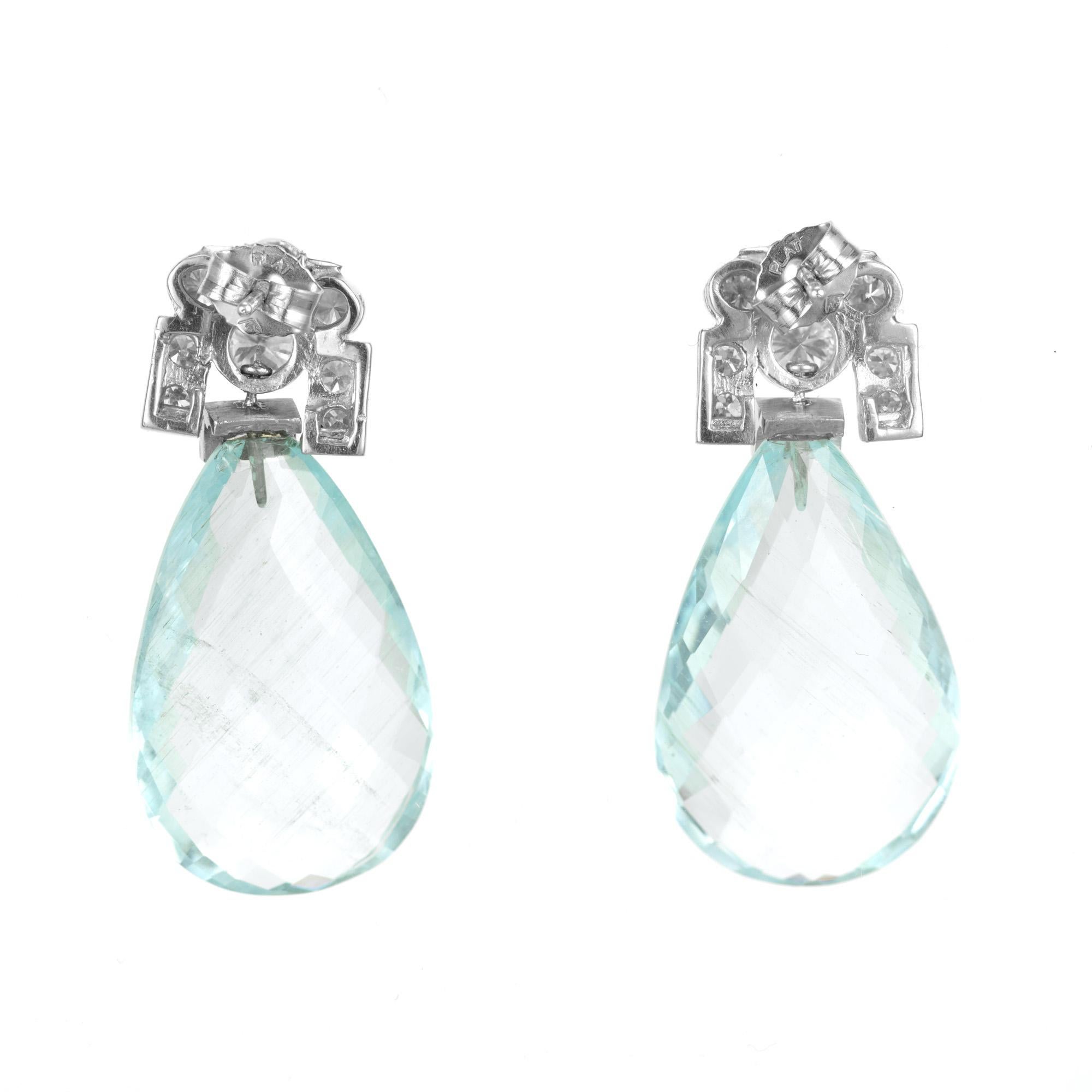 Beautiful briolette and diamond dangle earrings. Two large pear shape natural, untreated aquamarines totaling 27.00cts, with platinum tops that are adorned with bezel set round and emerald cut diamonds. Their mesmerizing aqua hue captures attention