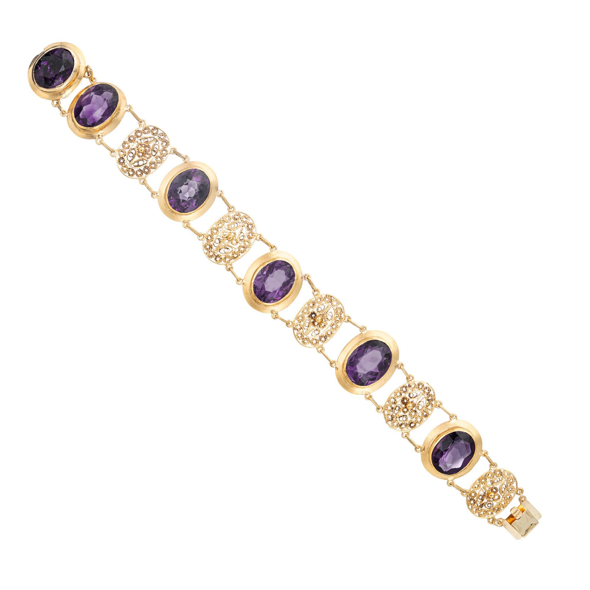 1970's Amethyst Filigree bracelet. 6 large warm oval amethyst bezel set amethysts totaling 27.00cts, set in 14k yellow gold with oval beautifully detailed filigree separators. A unique statement piece. 6.5 inches.  

6 genuine fine bright purple