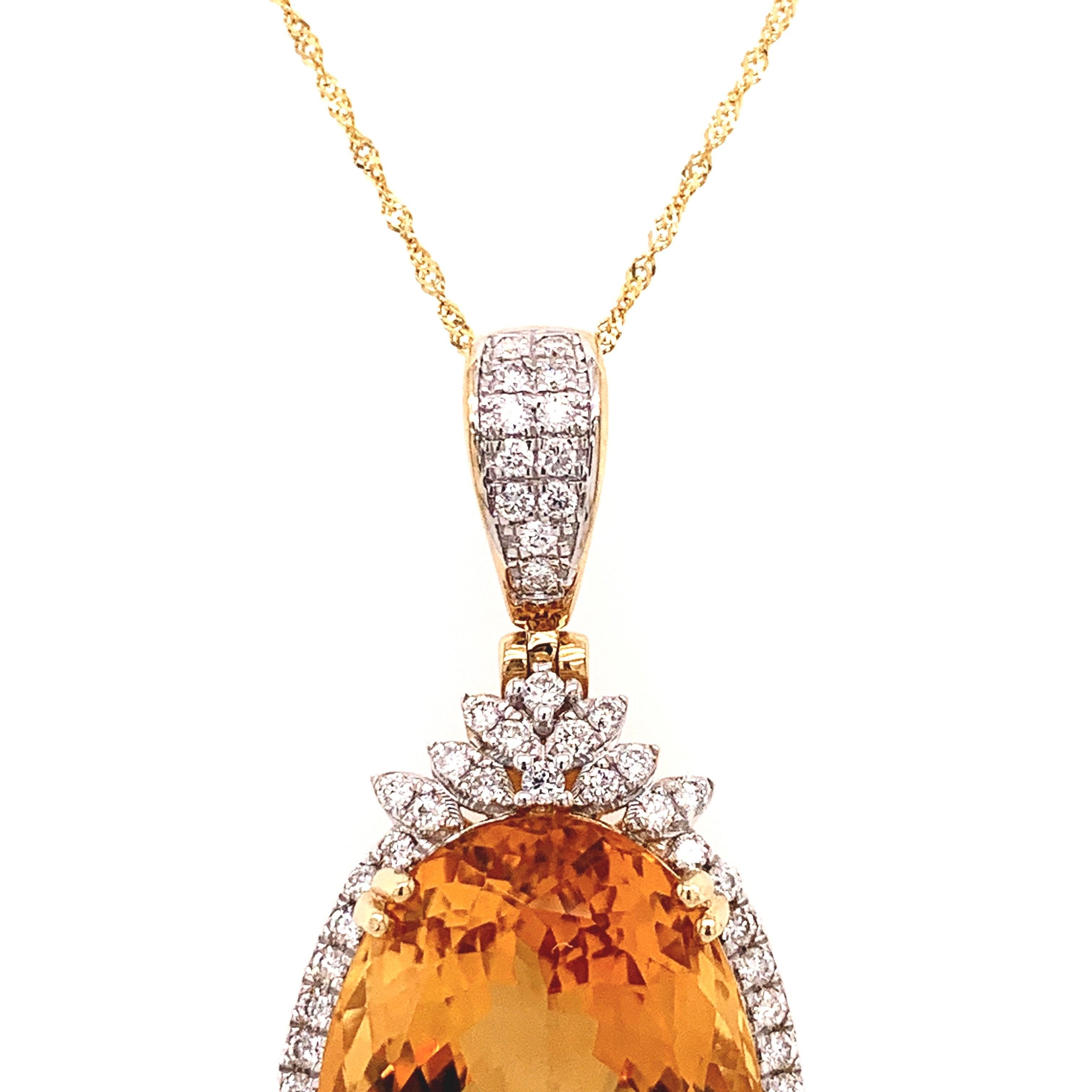 Stunning citrine diamond pendant. Lively deep golden honey yellow, high luster, natural oval faceted 27.04 carats citrine mounted in open basket with bead prongs, accented with round brilliant cut diamonds on the bail and encased the citrine.