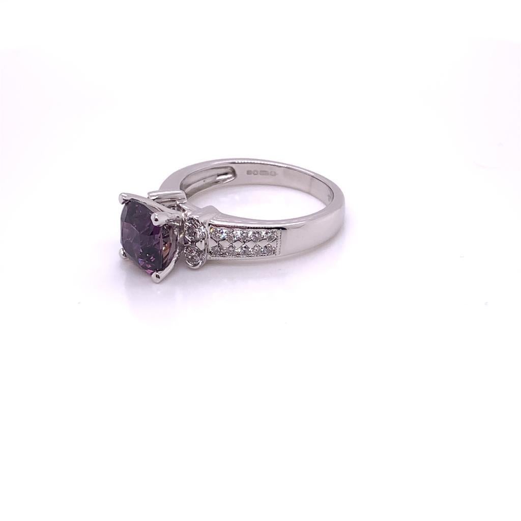 The eye-catching cushion cut purple sapphire that is at the centre of this dazzling ring weighs approximately 2.71 carats and is surrounded by approximately 0.32 carats of round brilliant diamonds, all set in 18k white gold. 