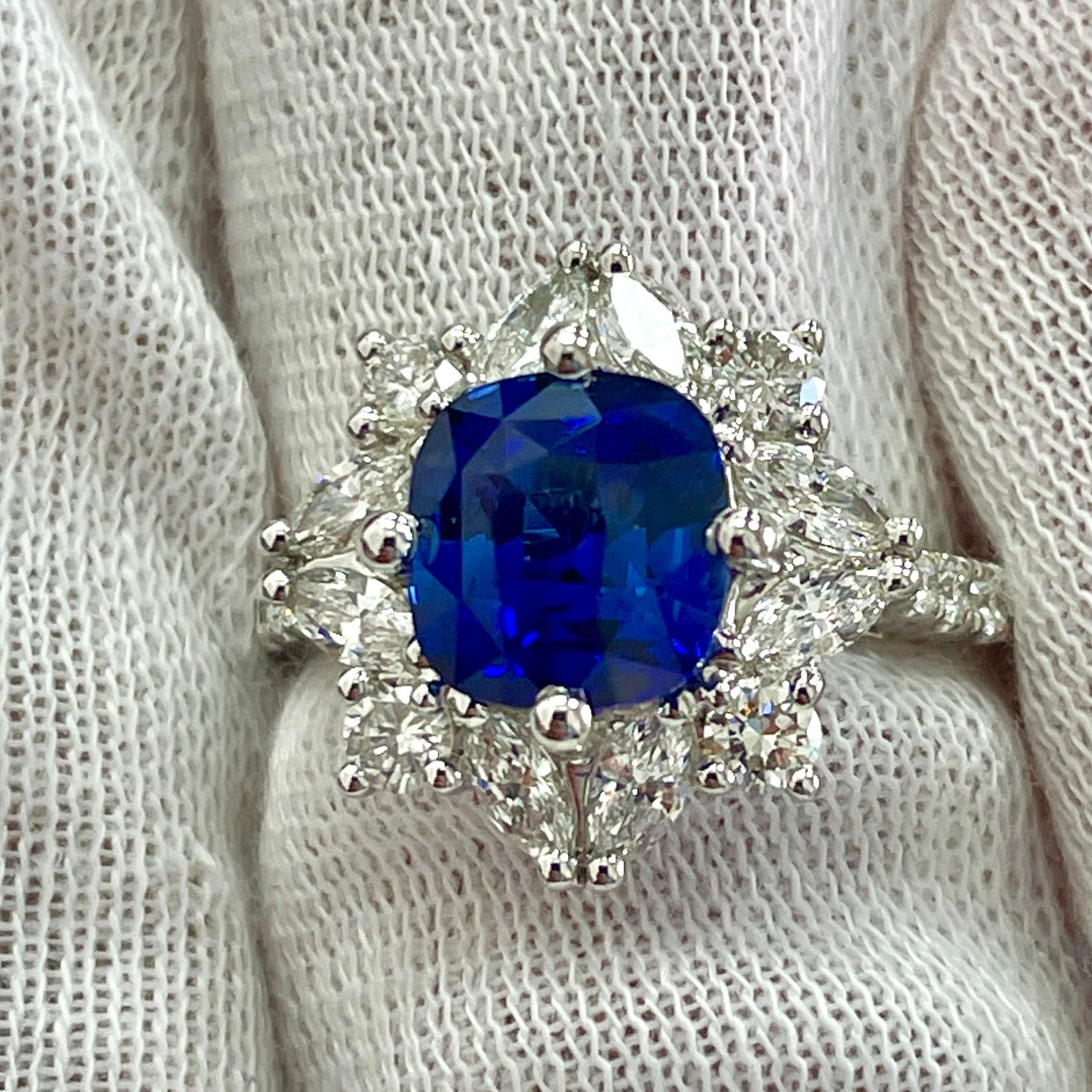 This is a vivid blue cushion cut sapphire mounted in an elegant 18K white gold ring with .99Ct of brilliant white diamonds. Suitable for any occasion!