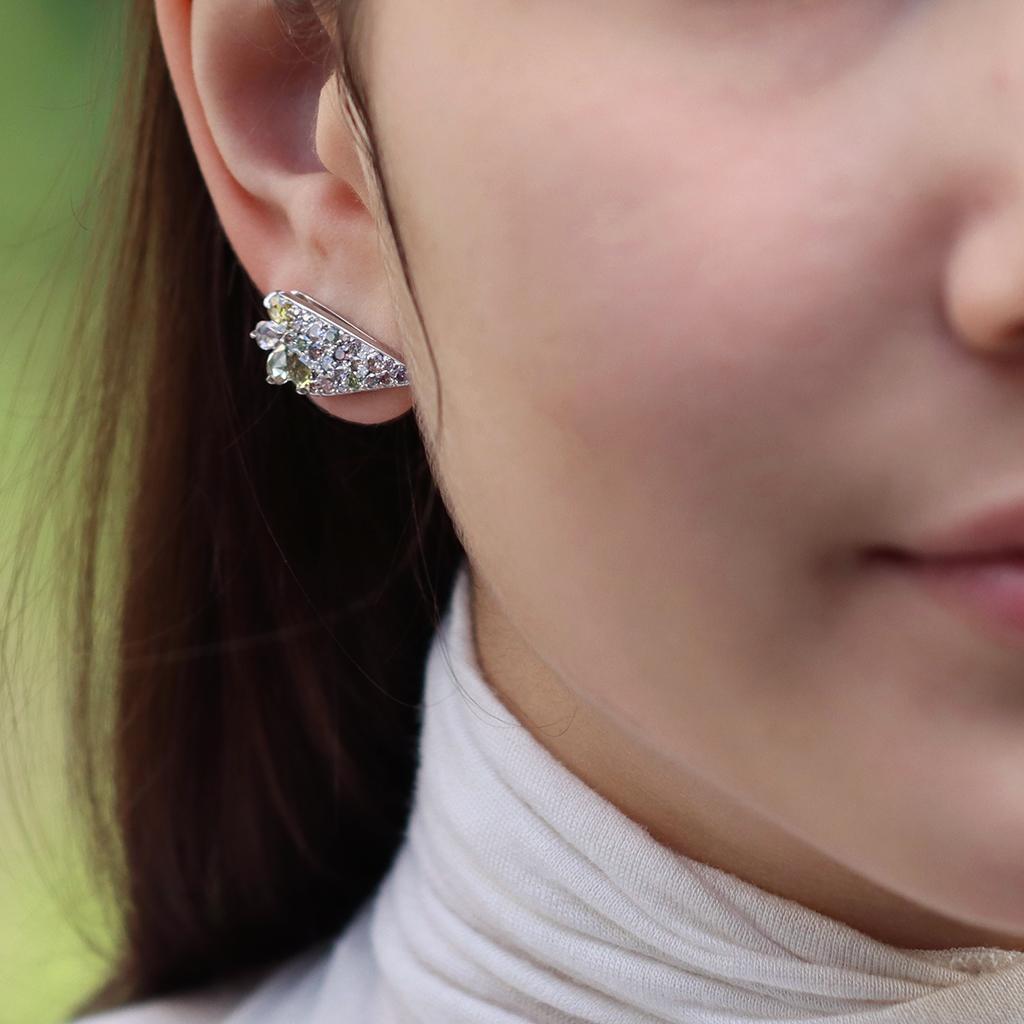 Wing Climber earrings by jewellery artist Joke Quick handmade in high-polished 18k white gold and showcasing 2.71 ct. of assorted fancy color rose-cut and brilliant-cut diamonds. These exquisite stones are carefully selected for their rarity,