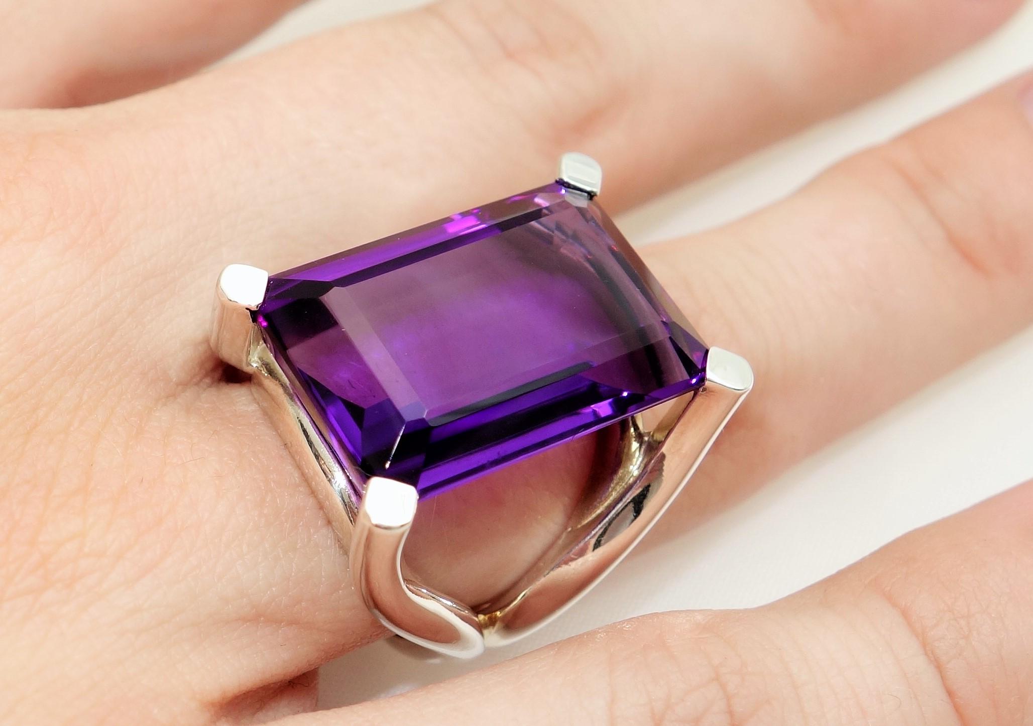Simply Beautiful Solitaire Ring featuring a 27.11 Carat Rectangular Amethyst Gem stone. Oxidized Sterling Silver Tarnish-resistant mounting; Size 7, we offer ring re-sizing. Stylish and Classy…illuminating your look with Timeless Beauty! 
