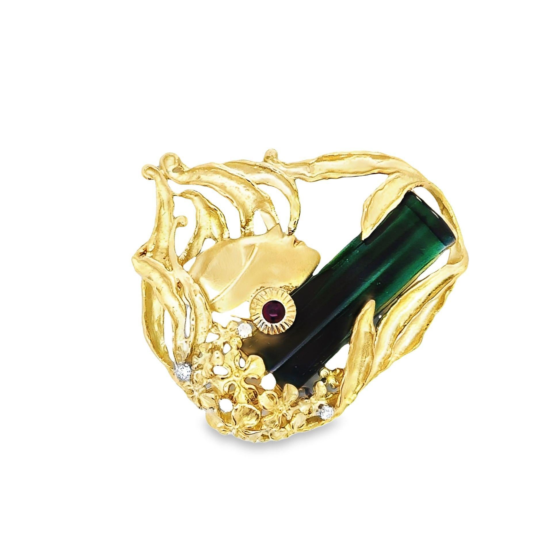 Crafted in 18k yellow gold, this brooch inspired by the Art Nouveau era is suitable for a glamorous outfit or for casual daily wear. It features an incredible green tourmaline of 27.16 carats which is surrounded by 0.15 carats of rubies and 0.12