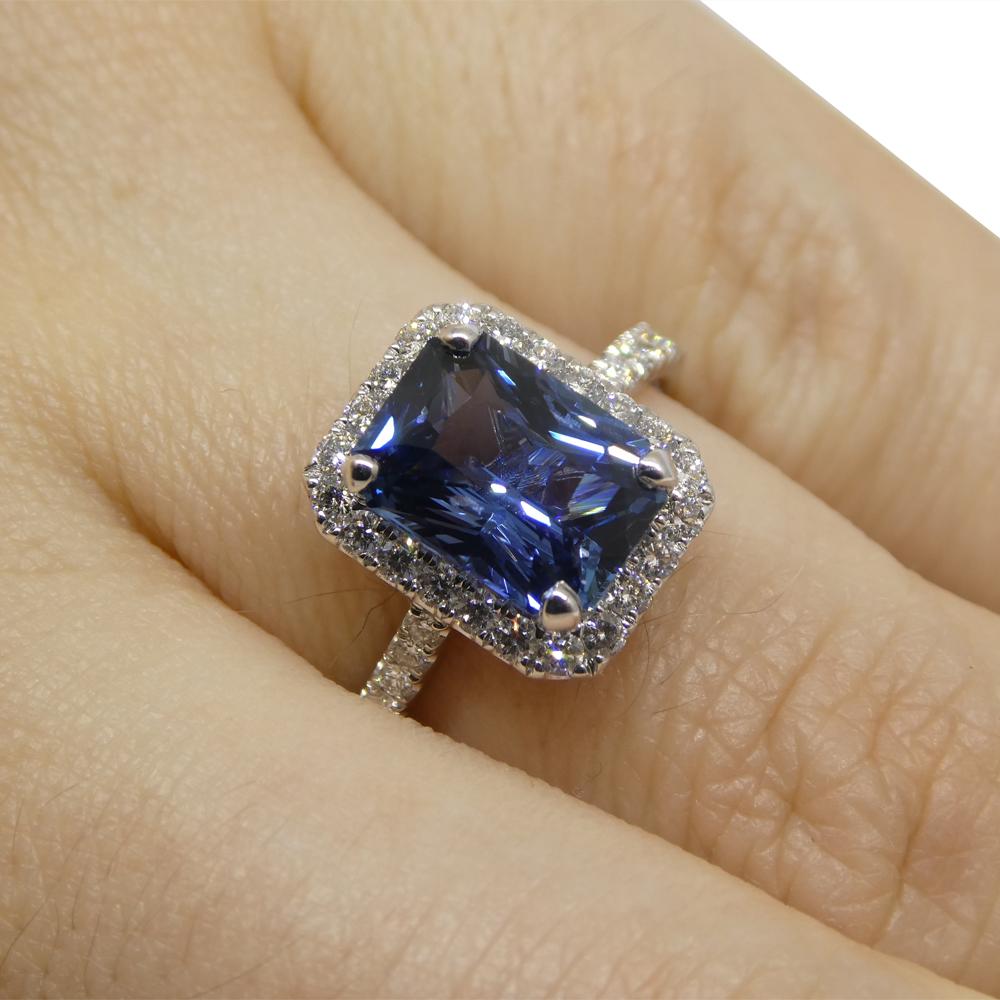  

Step into sophistication with our exquisite Radiant-Cut Sapphire and Diamond Ring, a symbol of timeless elegance. At its center shines a radiant-cut sapphire, weighing 2.71 carats. This sapphire, boasting a very slightly violetish blue hue,