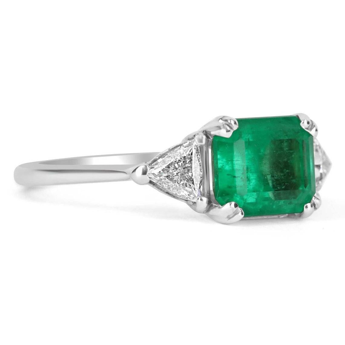 Featured is a Colombian emerald and diamond three stone engagement or right-hand ring. An extraordinary custom-created ring made by JR Colombian Emeralds. Dexterously crafted in gleaming 18K gold, this ring displays a 2.21-carat natural Colombian