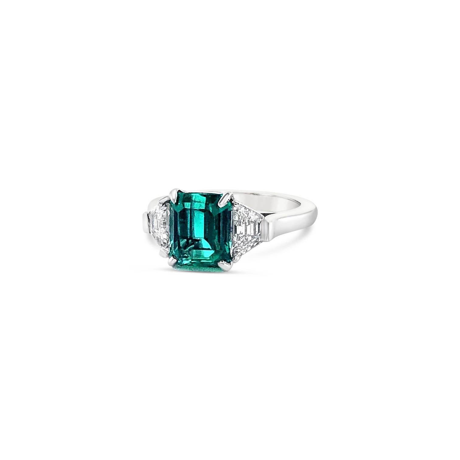 2.72 Carat Emerald and 0.83 Carat 'total weight' Trapeze cut Diamonds set as a Platinum ring. Diamonds are Color H-I, Clarity SI1-SI2.