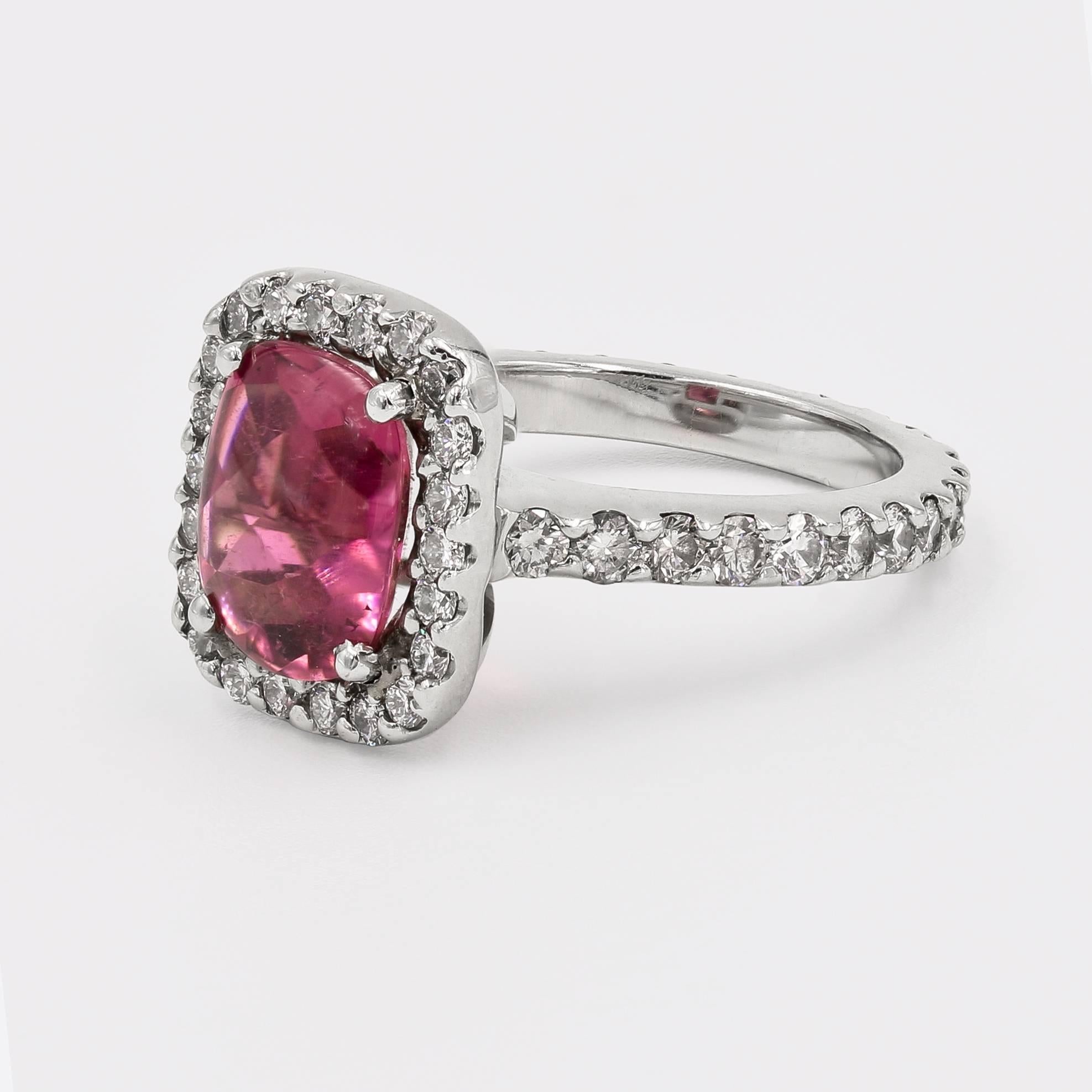 This beautiful platinum ring contains a 2.72cts. cushion shape cabochon cut Rhodolite Garnet center set in a halo style setting. Around the center and the entire shank are 48 ideal cut round diamonds=  1.19cts. t.w. (diamonds are G/VS)

Finger size