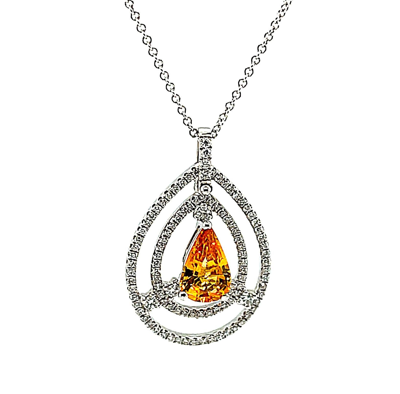 This beautiful pendant features a sleek, pear shaped yellow sapphire encircled by two diamond-studded halos for a truly unique and striking look. The pendant is elegant in design but large and impressive at the same time; a modern twist on early Art