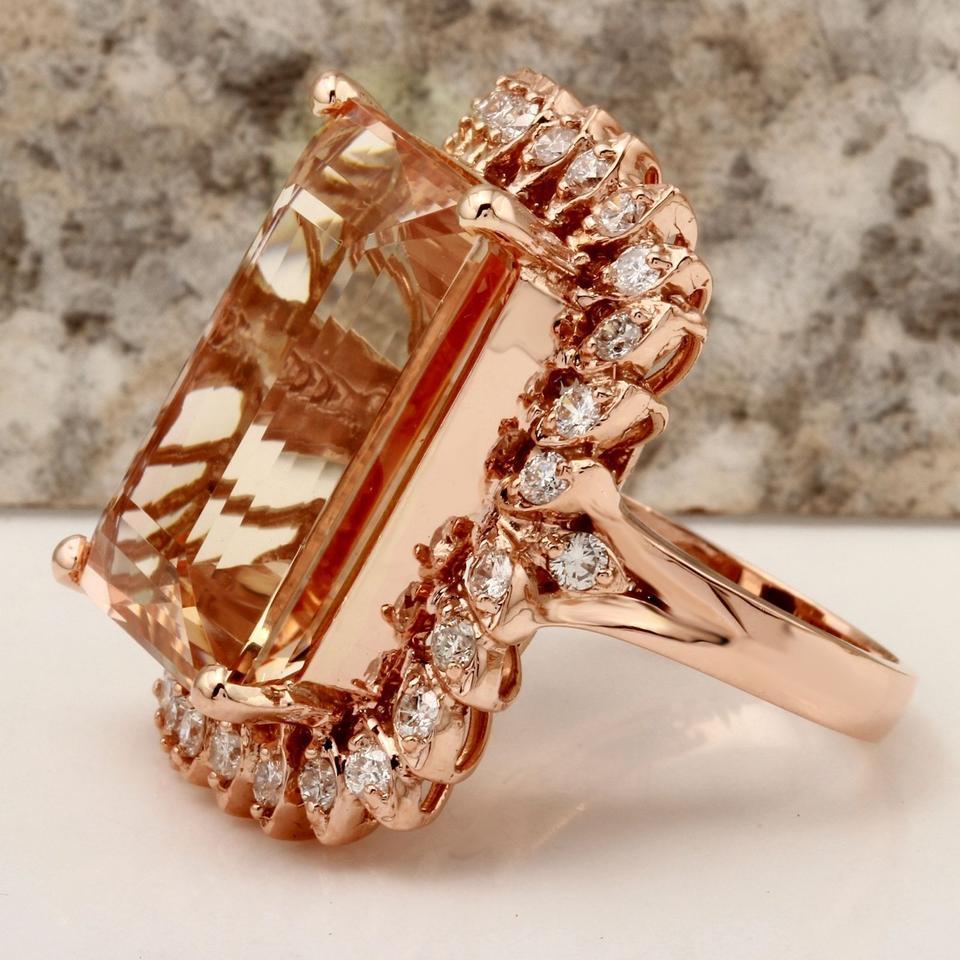 27.25 Carats Exquisite Natural Peach Morganite and Diamond 14K Solid Rose Gold Ring

Total Natural Morganite Weight: 26.00 Carats

Morganite Measures: 21.70 x 15.70mm

Head of the ring measures: 30.46 x 22.86mm

Natural Round Diamonds Weight: 1.25
