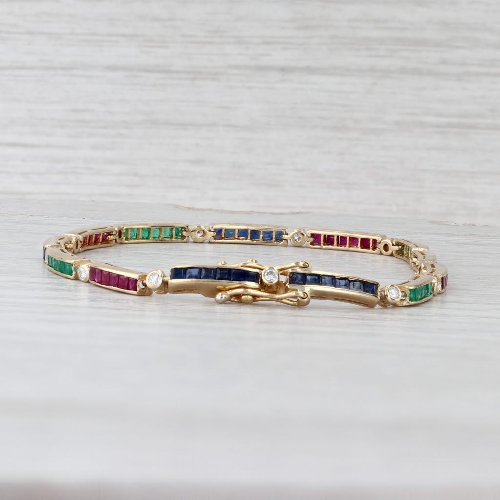 Gemstone Information:
- Natural Diamonds -
Total Carats - 0.20ctw
Cut - Round Brilliant
Color - F - G
Clarity - VS2 - SI1

- Natural Emeralds 0.72ctw, Sapphires 1ctw, Rubies 0.80ctw -
Cut - Square

Metal: 18k Yellow Gold
Weight: 7.9 Grams 
Stamps: