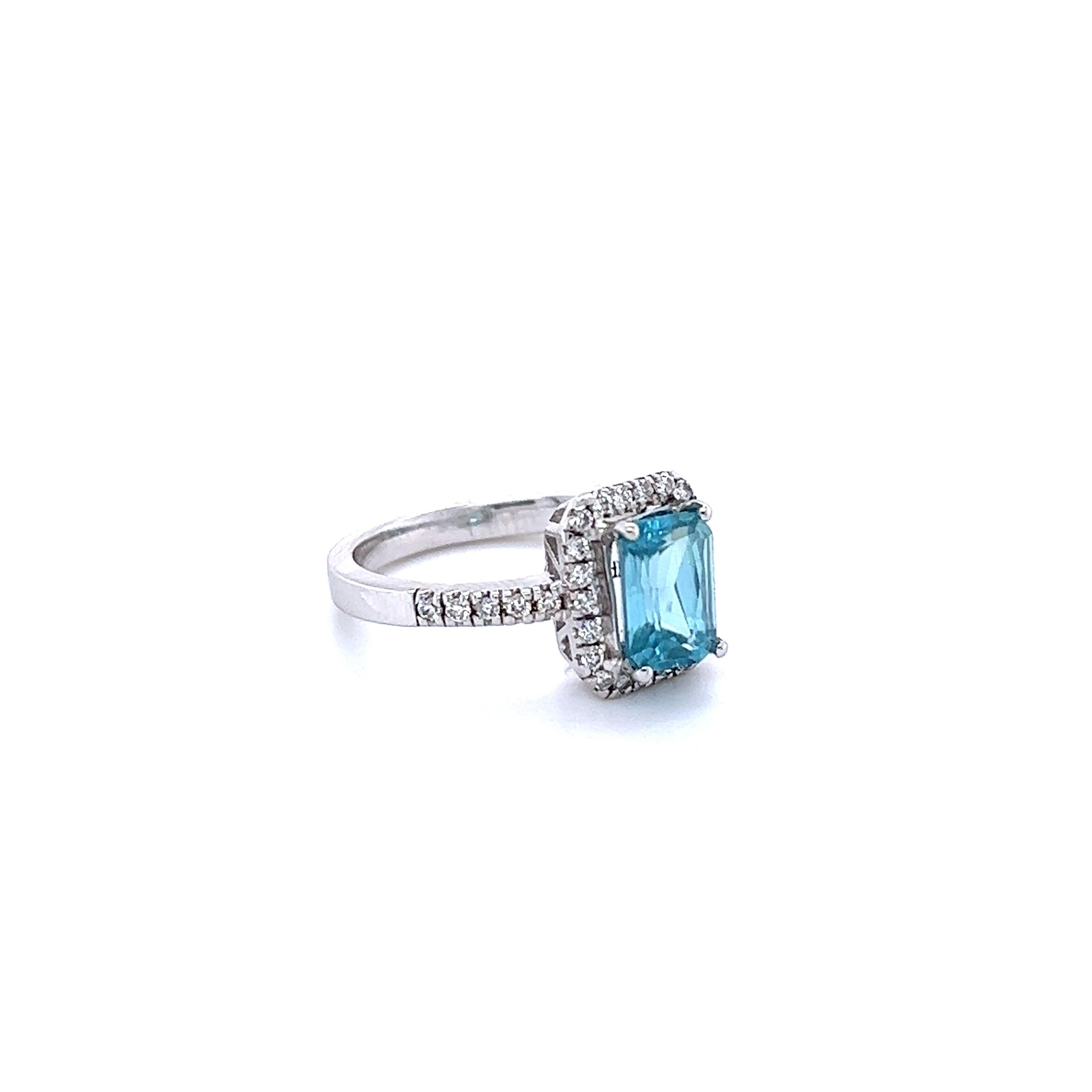 Blue Zircon is a natural stone mined mainly in Sri Lanka, Myanmar, and Australia.  
This ring has a Emerald Cut Blue Zircon that weighs 2.41 carats and is surrounded by 32 Round Cut Diamonds that weigh 0.32 Carats. The total carat weight of the ring