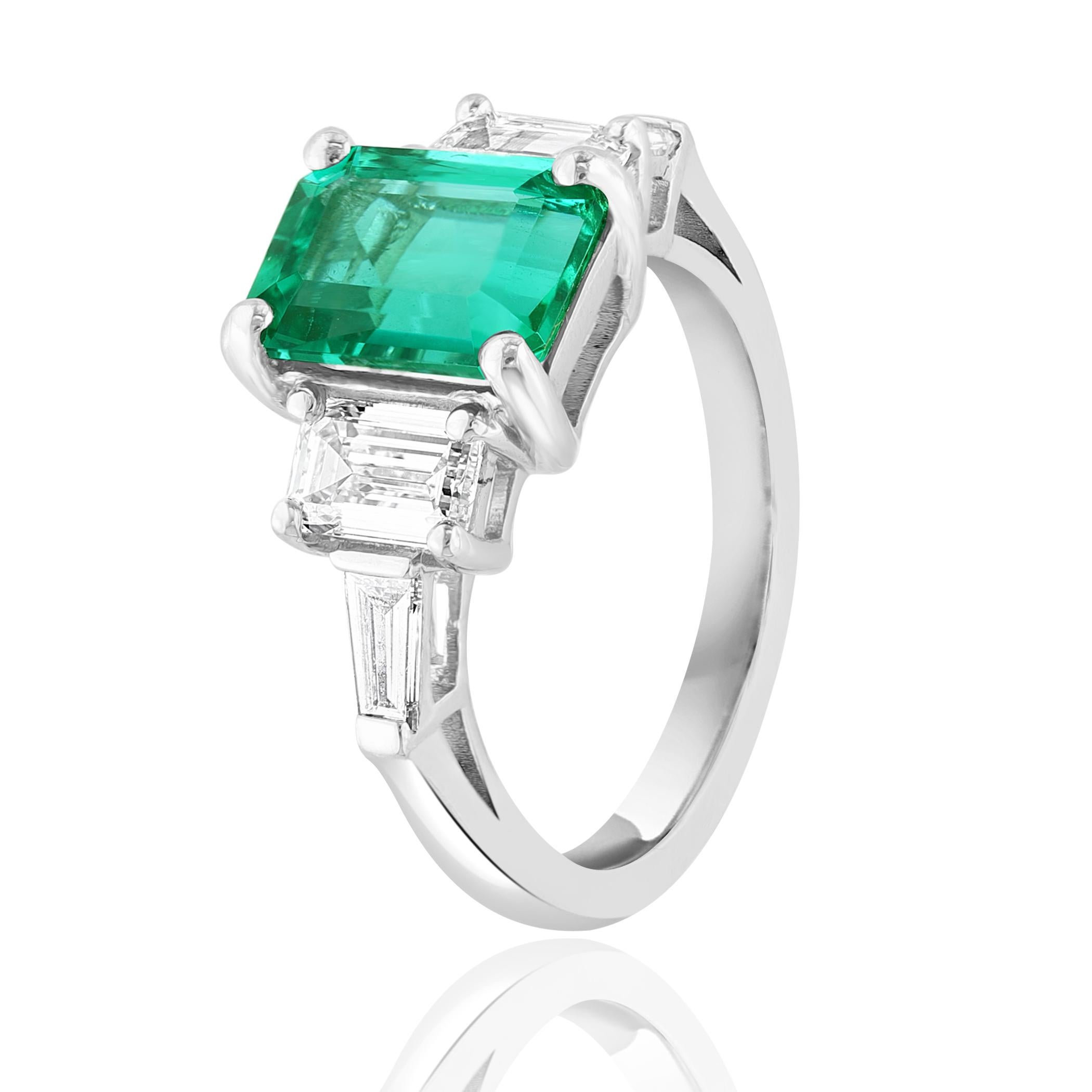 Showcasing color-rich 2.73 carat emerald. Two perfectly matched emerald cut diamonds weighing 1.03 carat elegantly flank the center emerald cut emerald for a very classy and sophisticated piece. Additional 2 bullets cut diamonds weigh 0.20-carat