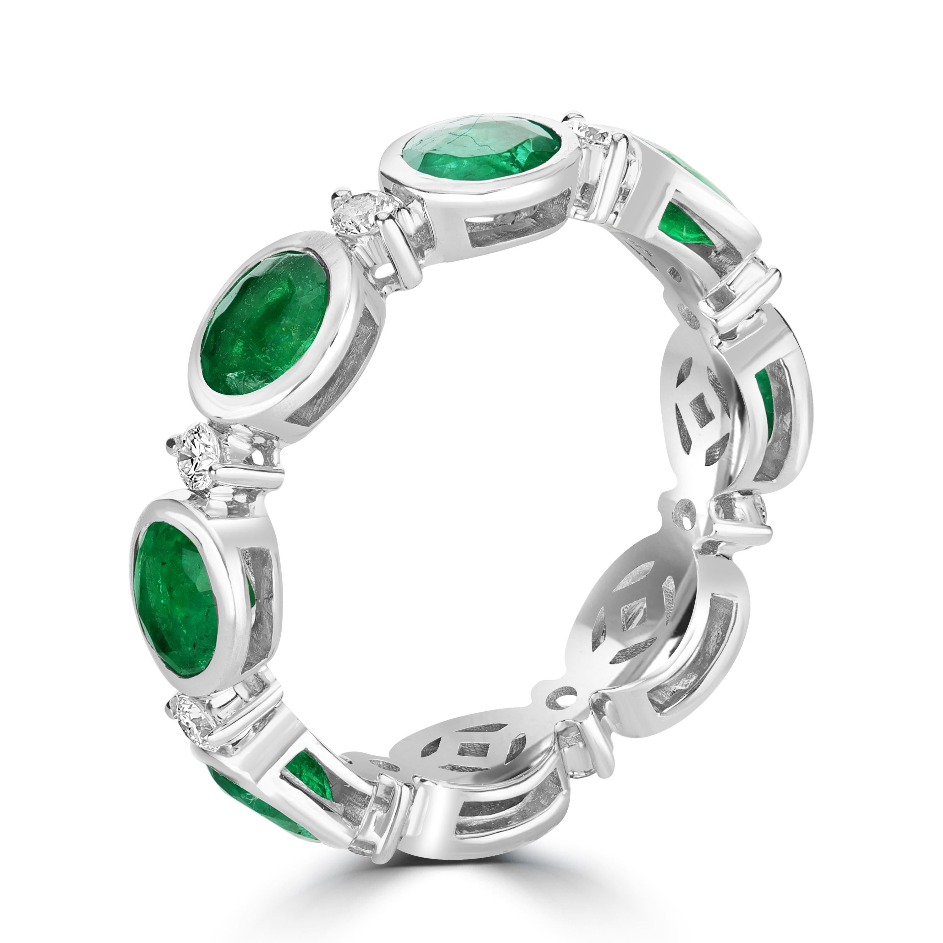 This spectacular emerald and diamond eternity band ring is the one for your jewelry collection. Set in bezel setting, this ring has emeralds from Zambia known for its exquisite bluish green hue, The diamonds used are of G-H color and SI clarity. The