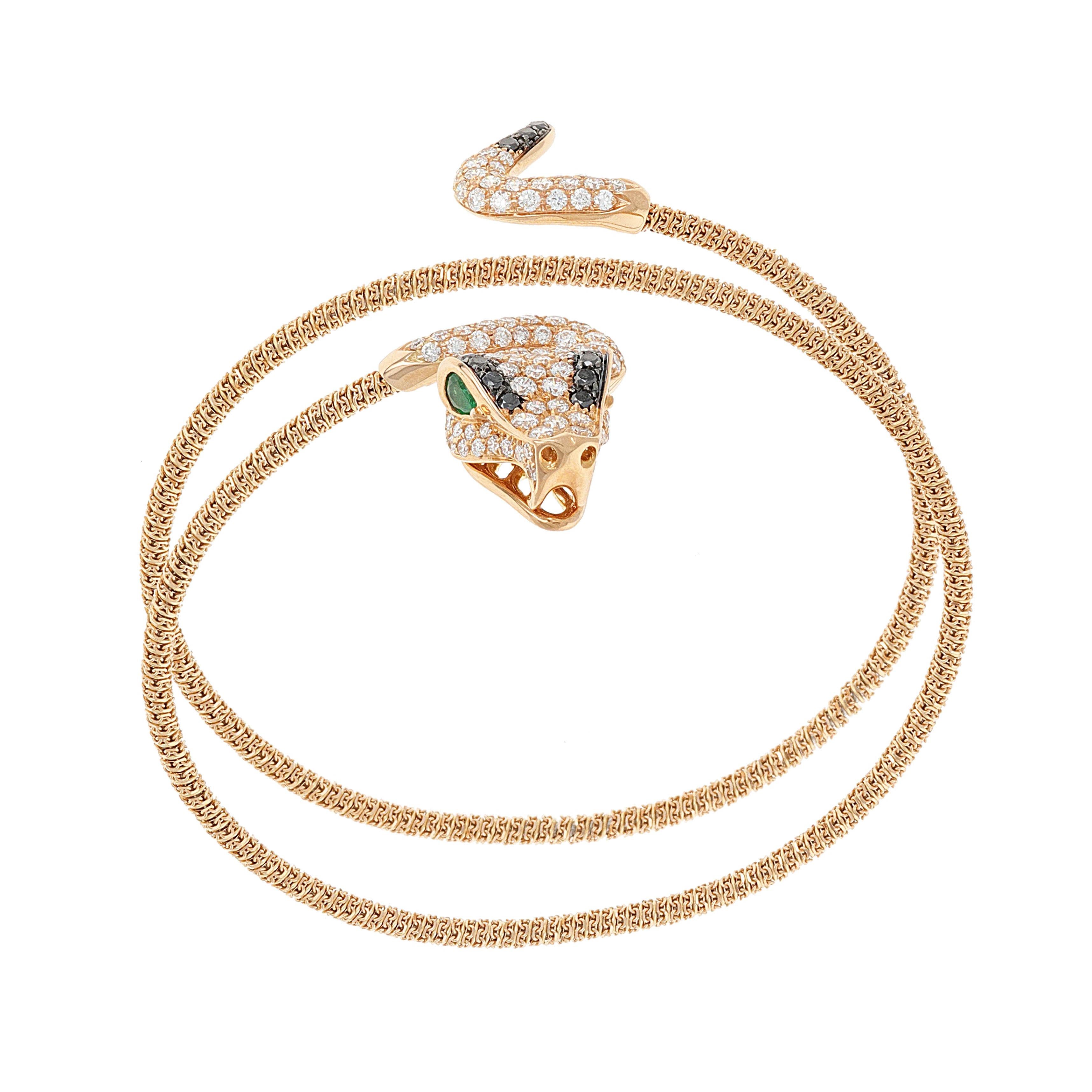 18 karat rose gold and titanium diamond and emerald snake cuff bangle. This bracelet is flexible and made so you can wrap it around your wrist and/or arm. The snakes head and tail is adorned in diamonds and emeralds. There are a total weight of 2.23
