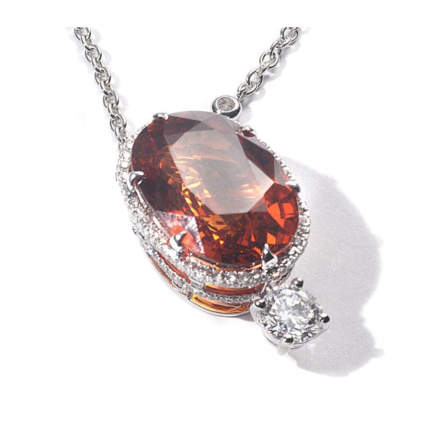 Stunning necklace set in 18 Karat White Gold with Mandarin Garnet (Spessartite) weighing approximately at 27.31 carats and Diamonds at 1.02 carats. All stones were hand-cut and hand-polished, enhancing the beauty of this hand-crafted piece made by