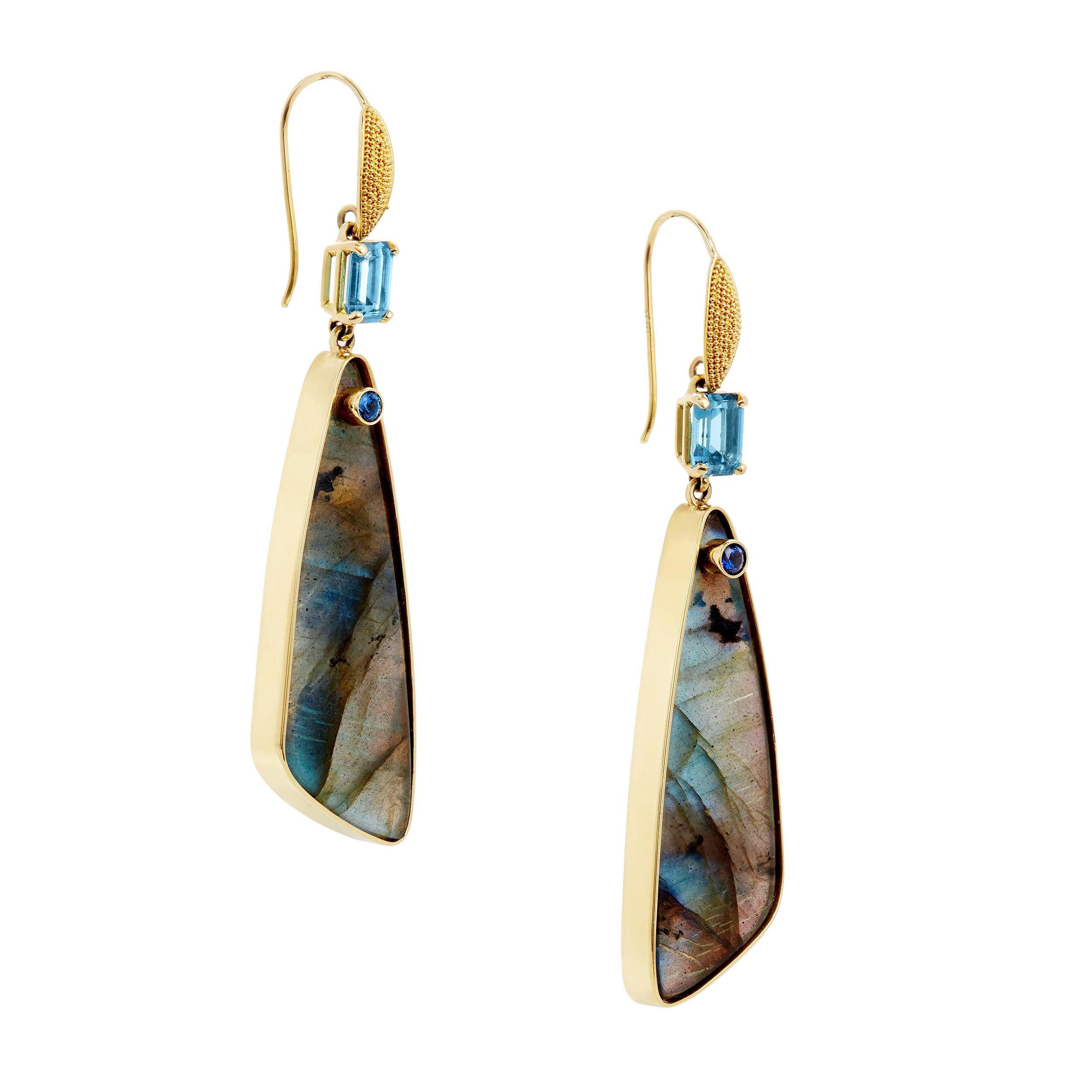 Sophisticated beauty. These are gorgeous earrings that dangle with flowing movement. Perfect for any occasion from casual to evening wear.

Trillion Labradorite (2) 14 x 41 mm 24.64 Carats
Emerald Cut London Blue Topaz (2) 2.48 Carats
Blue Sapphires