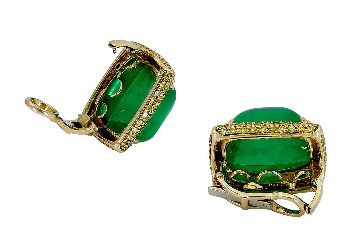 A unique and large pair of earrings showcasing sugarloaf cabochon emeralds, surrounded by micro-pave set yellow diamonds in 18k yellow gold. 
Emeralds weigh 27.38 carats total.
Yellow diamonds weigh 1.79 carats total.
0.91 inches (L) x 0.84 inches